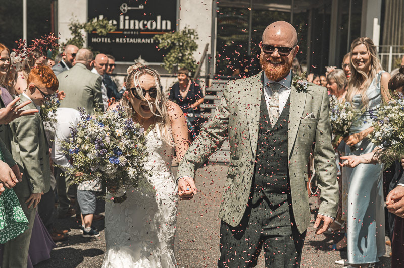 Bride and groom outside Lincoln Hotel on their wedding day