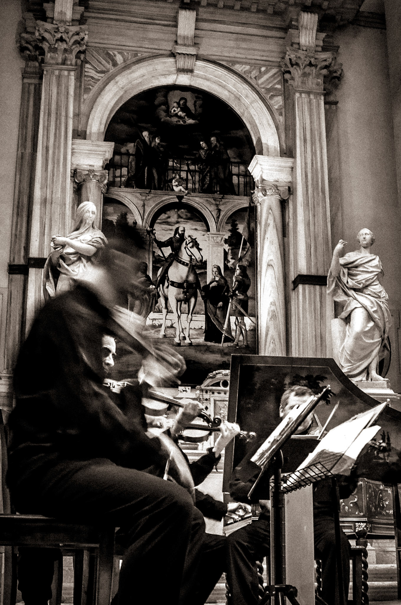 A single frame from an evening concert. The musicians are blurred by movement, while the church remains still. The photograph is less about who performed than about the feeling of live music echoing through an old building.