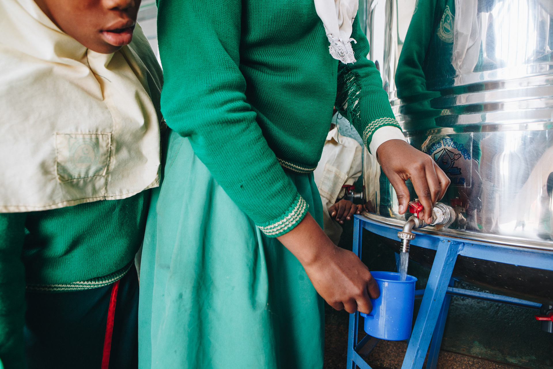 Clean drinking water at school in Uganda - editorial for non-profit Yunus Social Business (YSB)