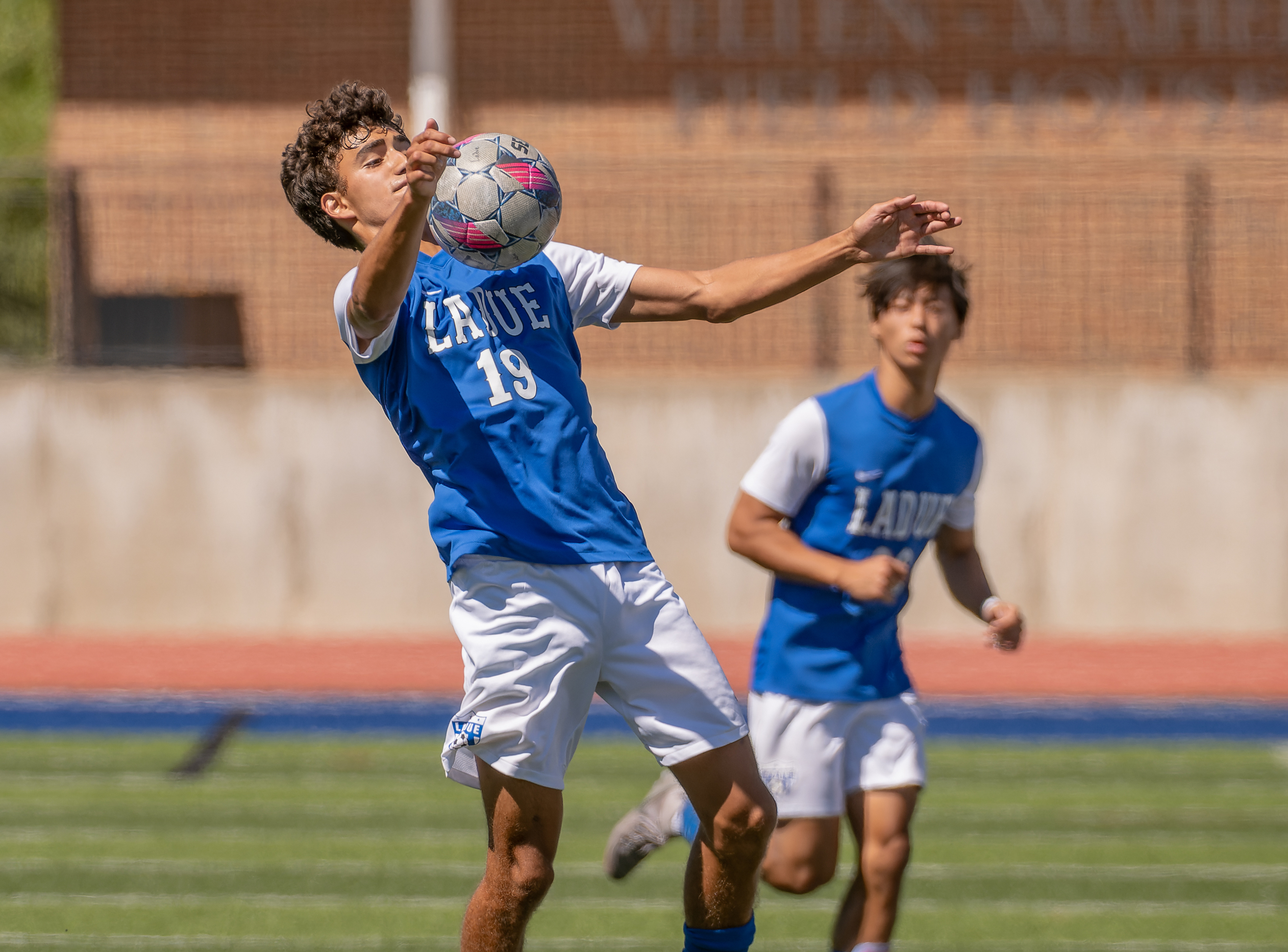 Ladue's Eli O'Neal (12) chests the ball as Jeha Hwang (11) runs in for defense during a soccer game against the Timberland Wolves, Saturday, Sept. 7, 2024, at Ladue Horton Watkins High School in Ladue, Missouri. The Wolves won over the Ladue Rams 2-1 in overtime penalty kicks, ending their 3-game win streak.