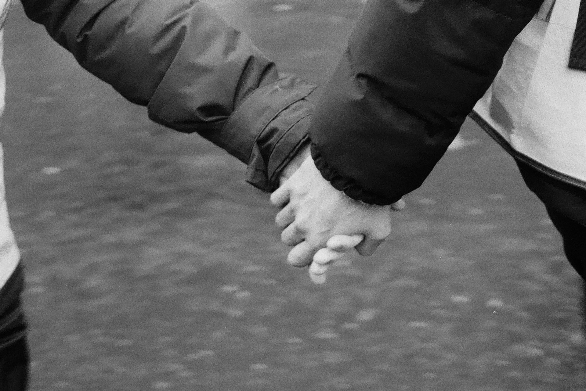 Two people holding hands at a strike in support of Palestine across from Saint Paul's Cathedral, London, UK. December 2023.