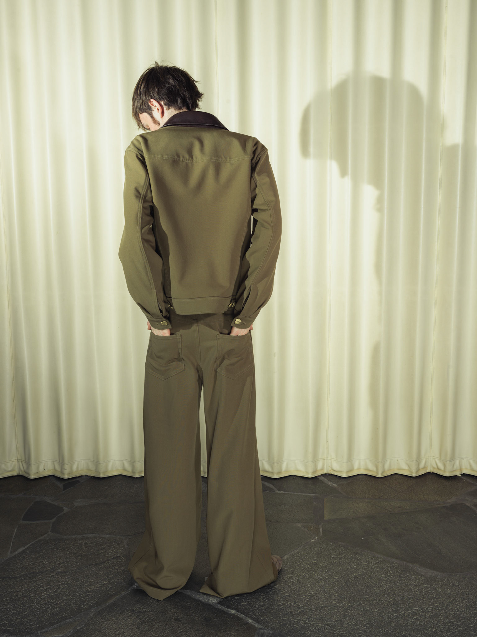 Virgin wool trucker jacket and wide-leg trousers set, Both with handmade brass buttons and deer leather details, Silk striped button-up shirt