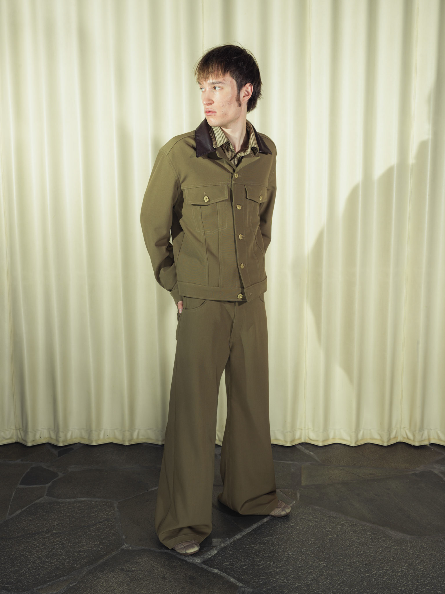 Virgin wool trucker jacket and wide-leg trousers set, Both with handmade brass buttons and deer leather details, Silk striped button-up shirt