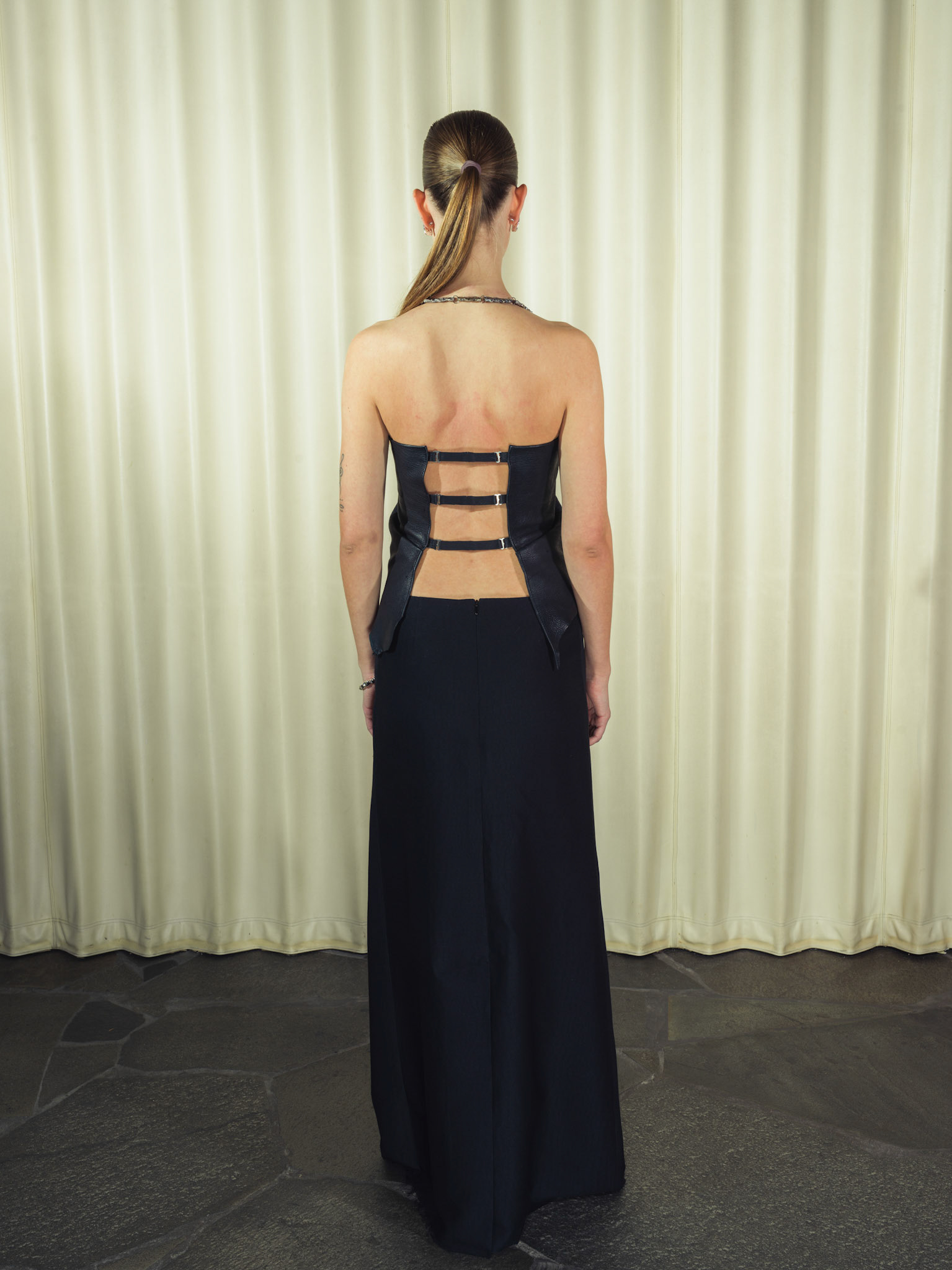 Draped raw edge deer leather top with handmade silver hardware, Jacquard silk wool maxi skirt