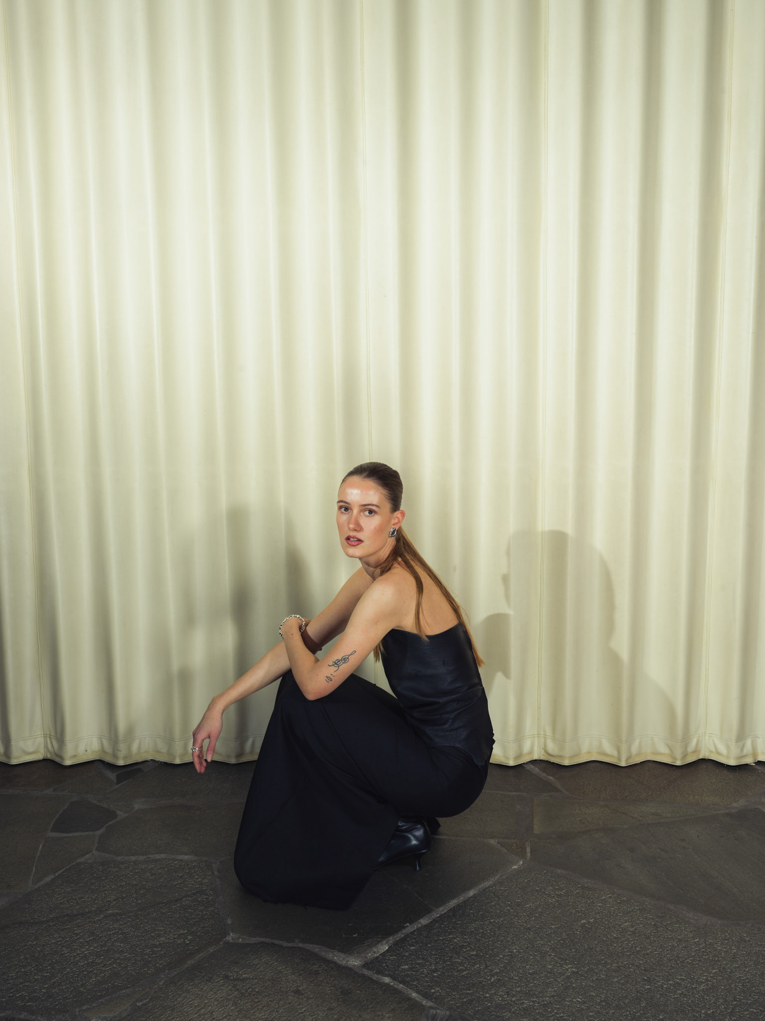 Draped raw edge deer leather top with handmade silver hardware, Jacquard silk wool maxi skirt