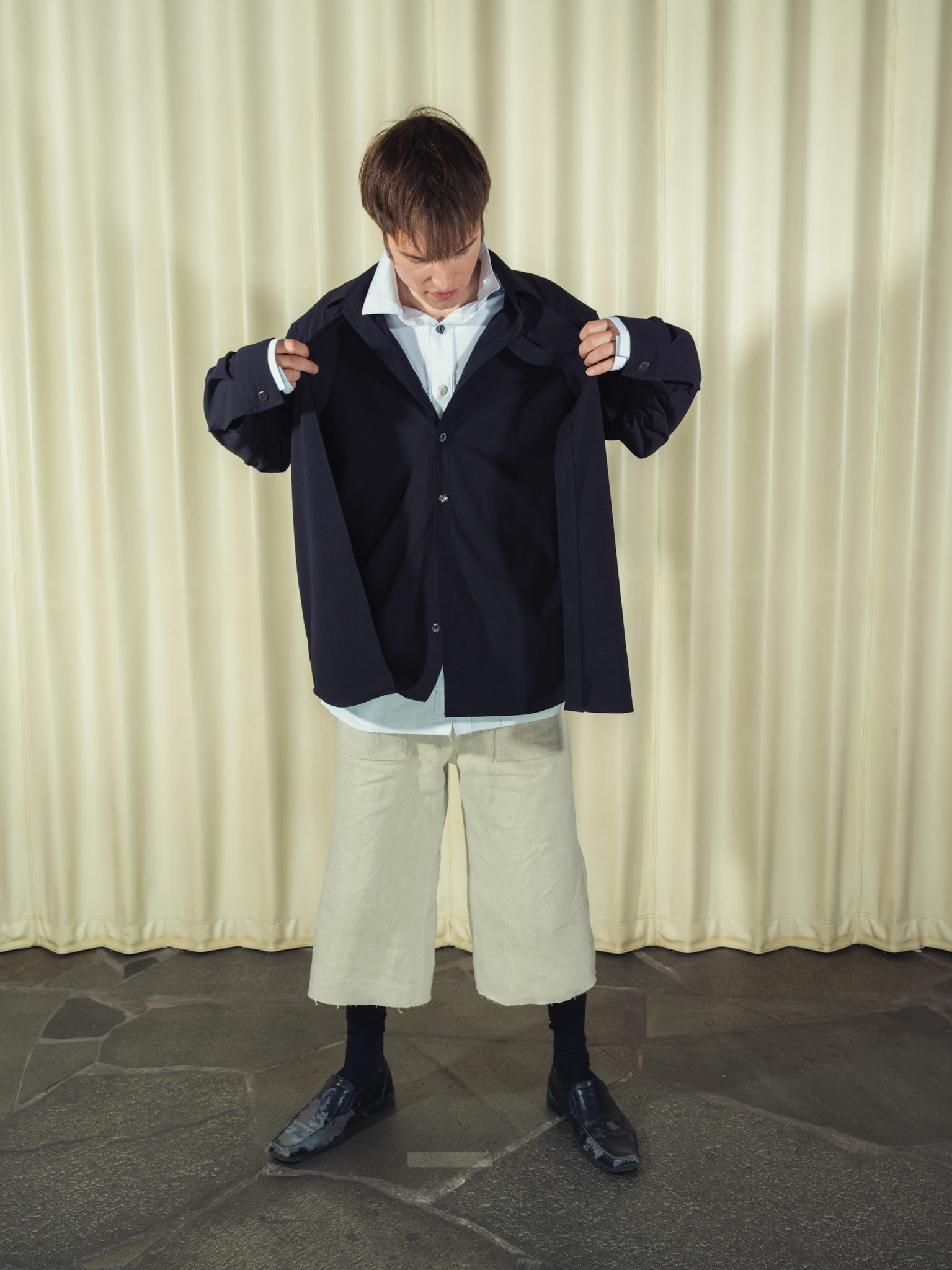 Asymmetric double-layered cotton button-up shirt and Cotton button-up shirt with fringe details, Both featuring handmade ceramic buttons, Hemp shorts with fringe details