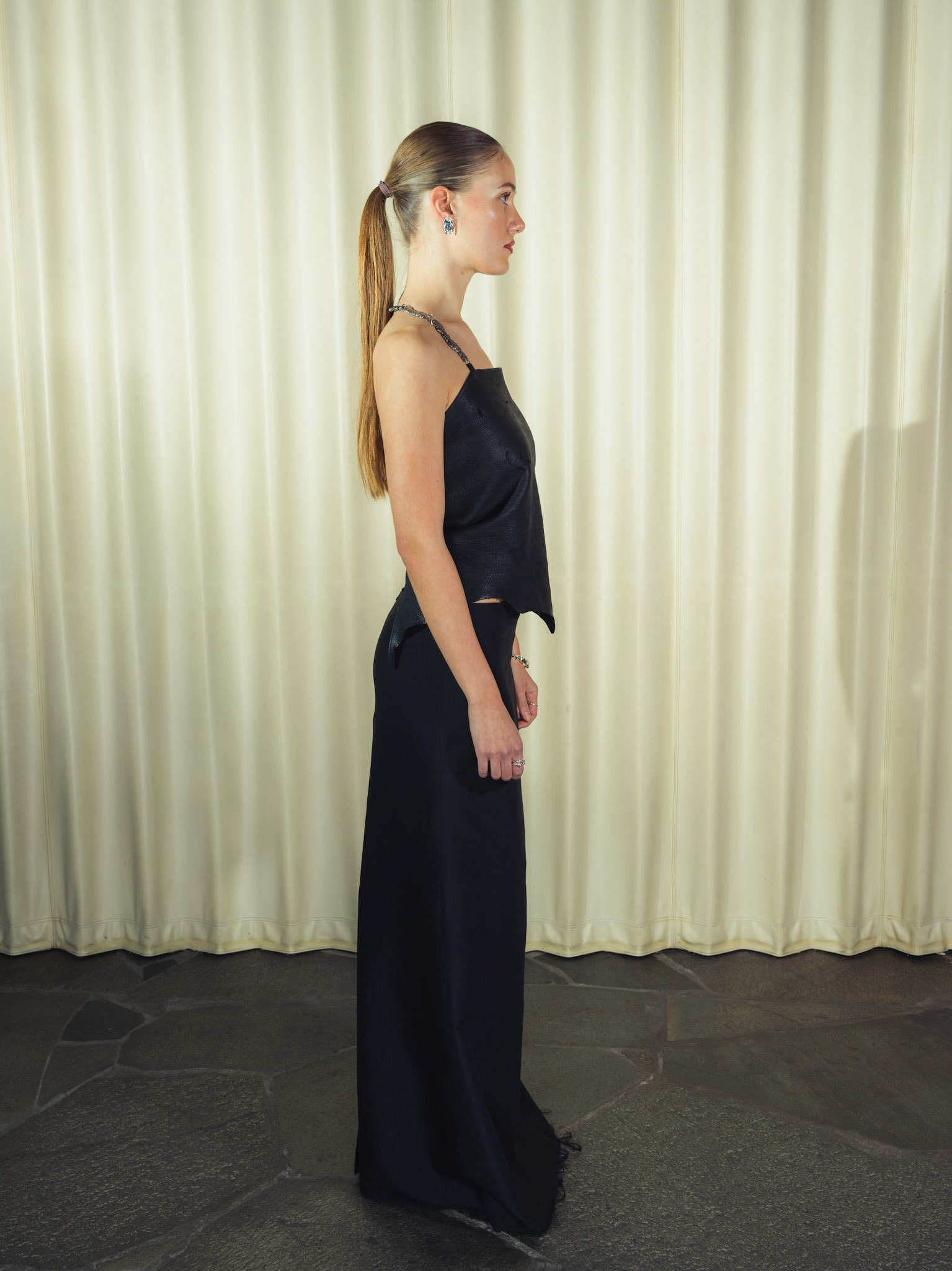 Draped raw edge deer leather top with handmade silver hardware, Jacquard silk wool maxi skirt