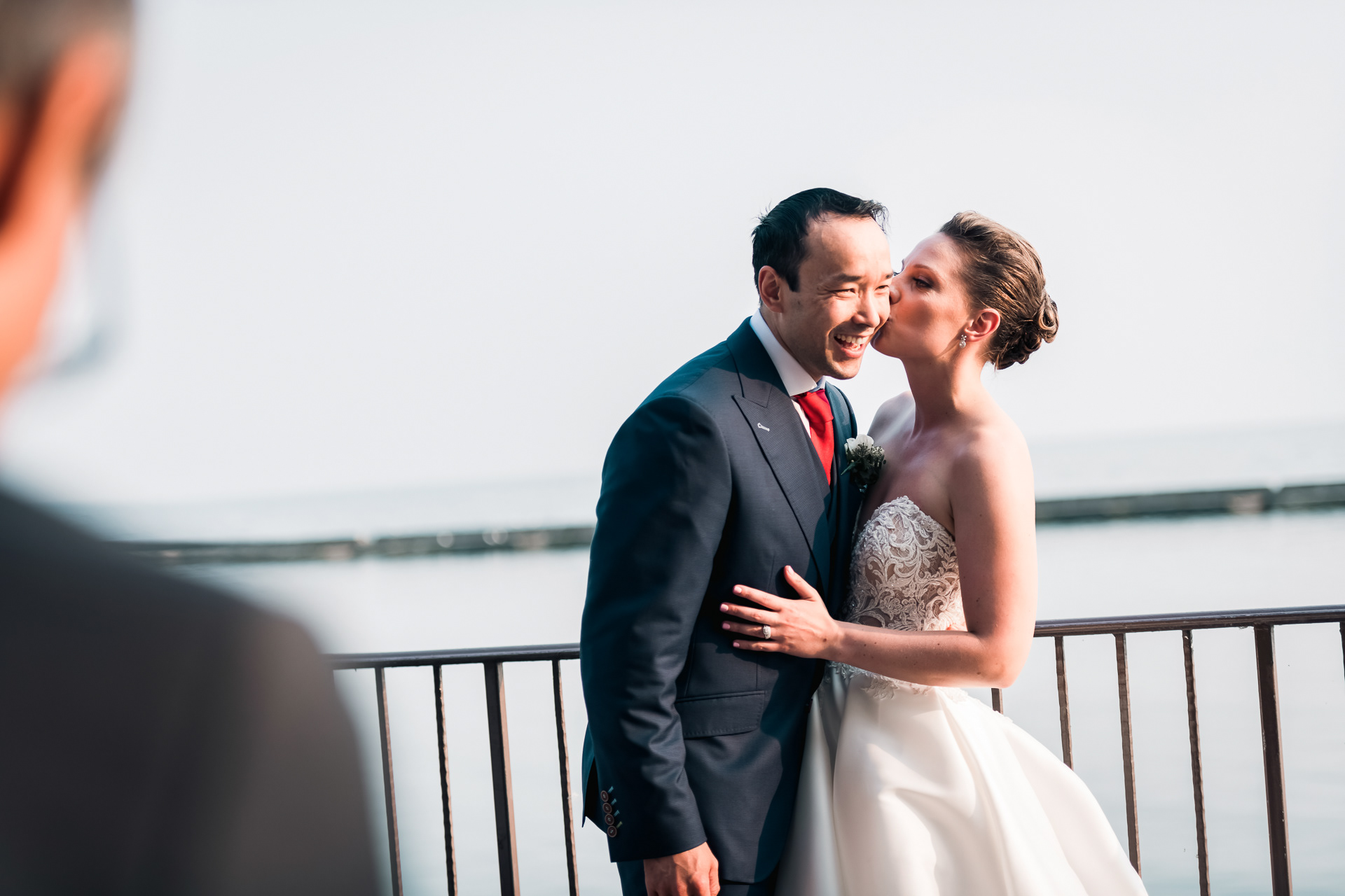 Bride and groom smiling and laughing together on the terrace.