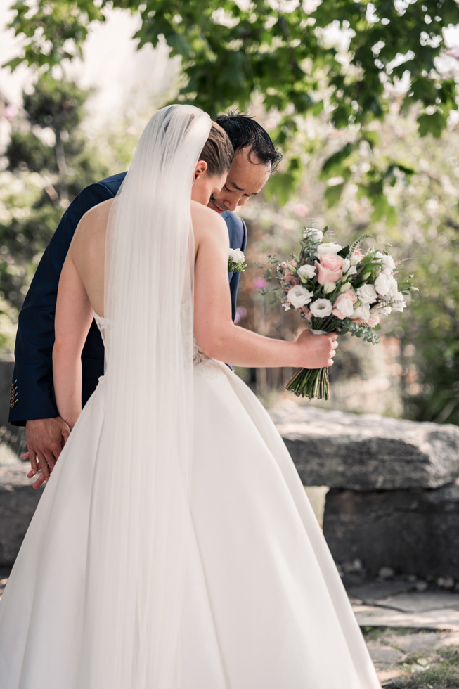 Romantic portrait of bride holding bouquet while sees her for the first time.