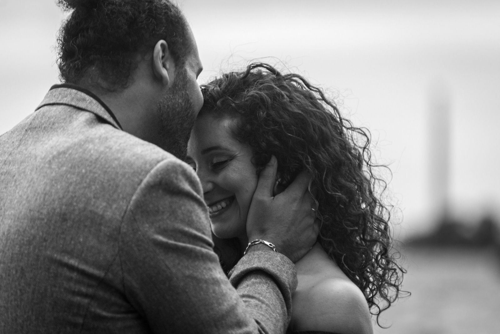 Black and white close-up of couple sharing an intimate moment by the Toronto waterfront.