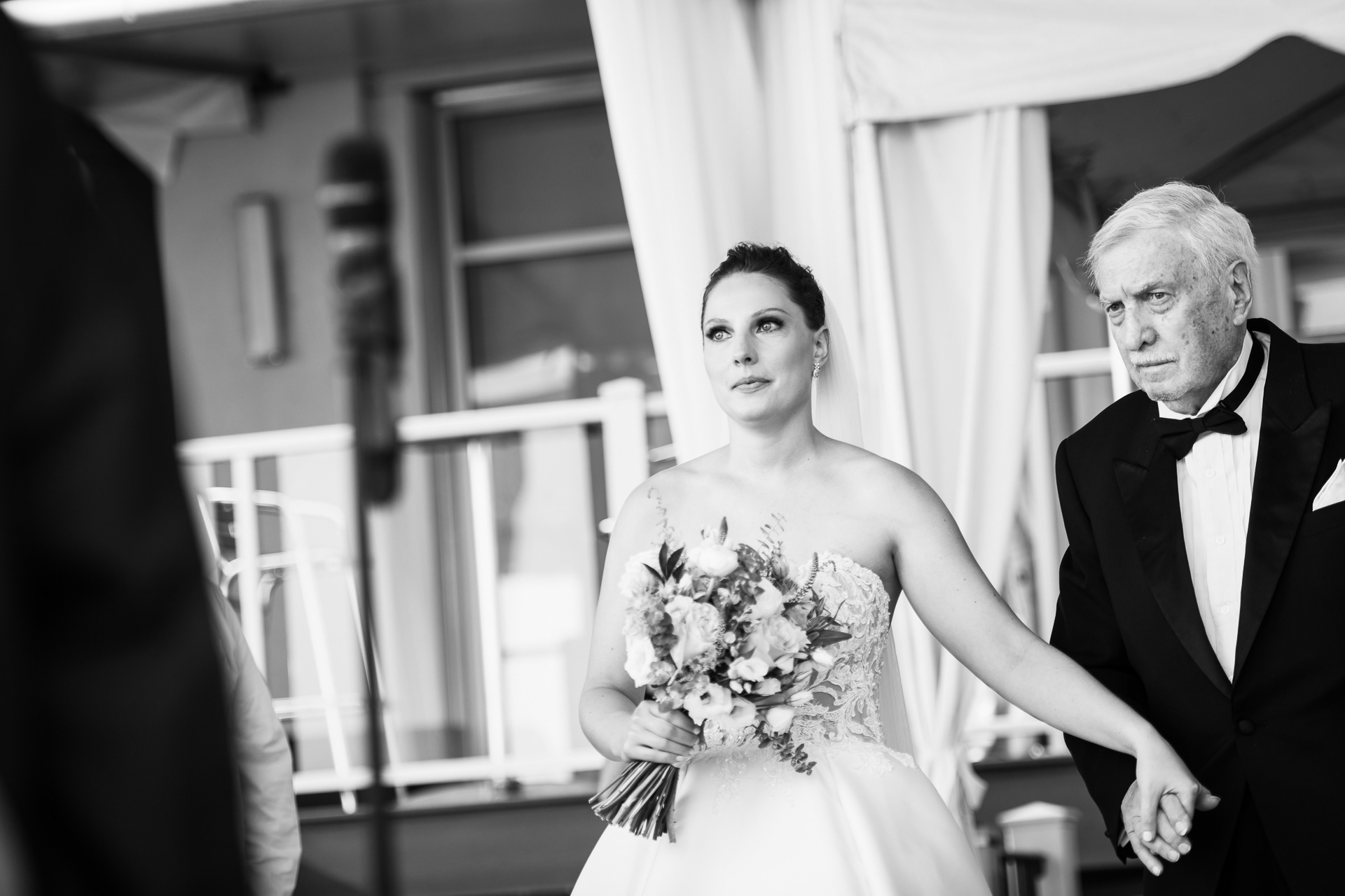Bride walking arm-in-arm with her father during the processional.