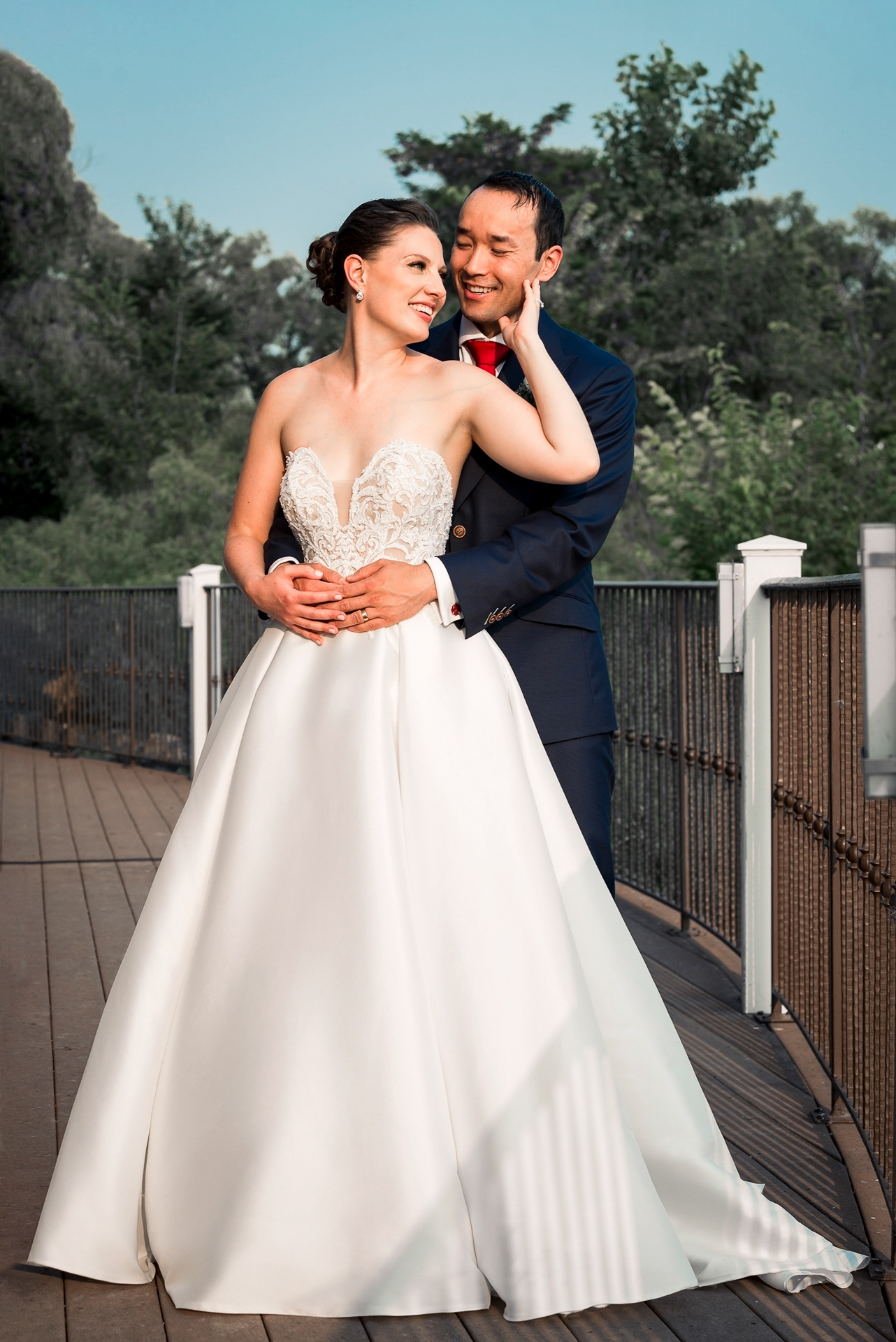 Bride and groom embracing outdoors at Palais Royale waterfront.
