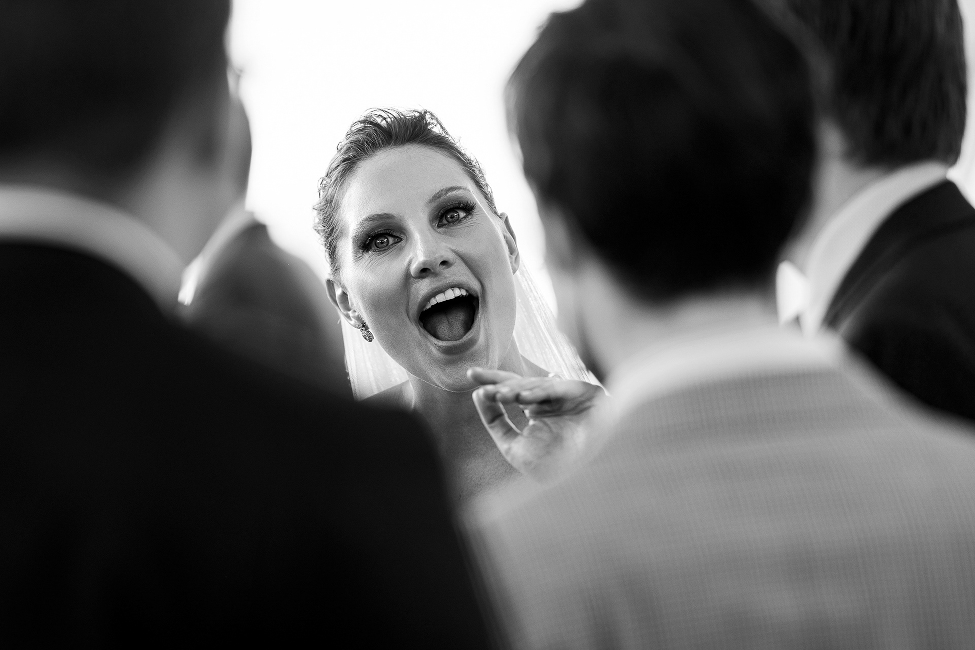 Bride laughing and chatting with guests during cocktail hour.