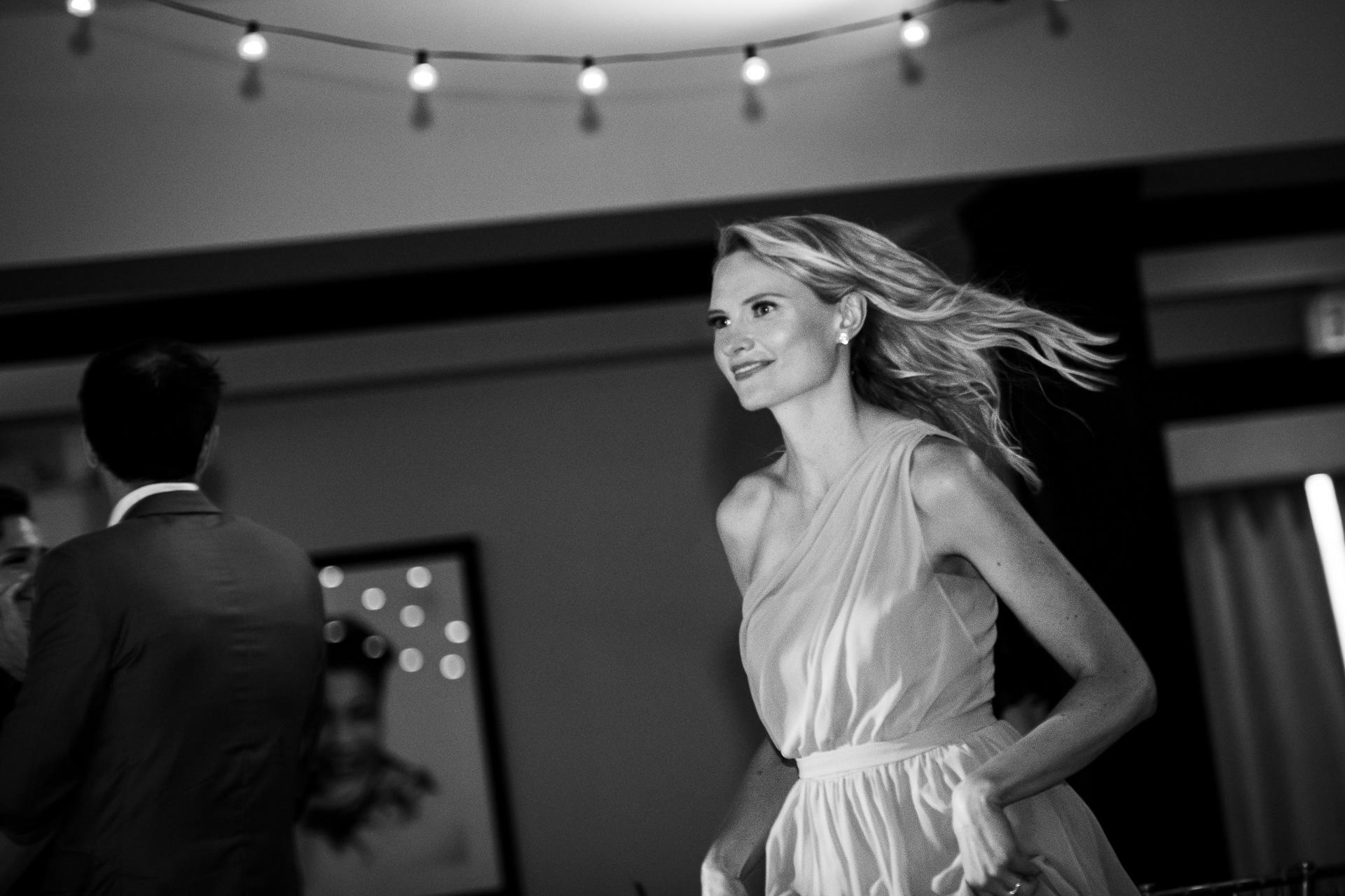 Bridesmaid making her way joyfully into the reception.