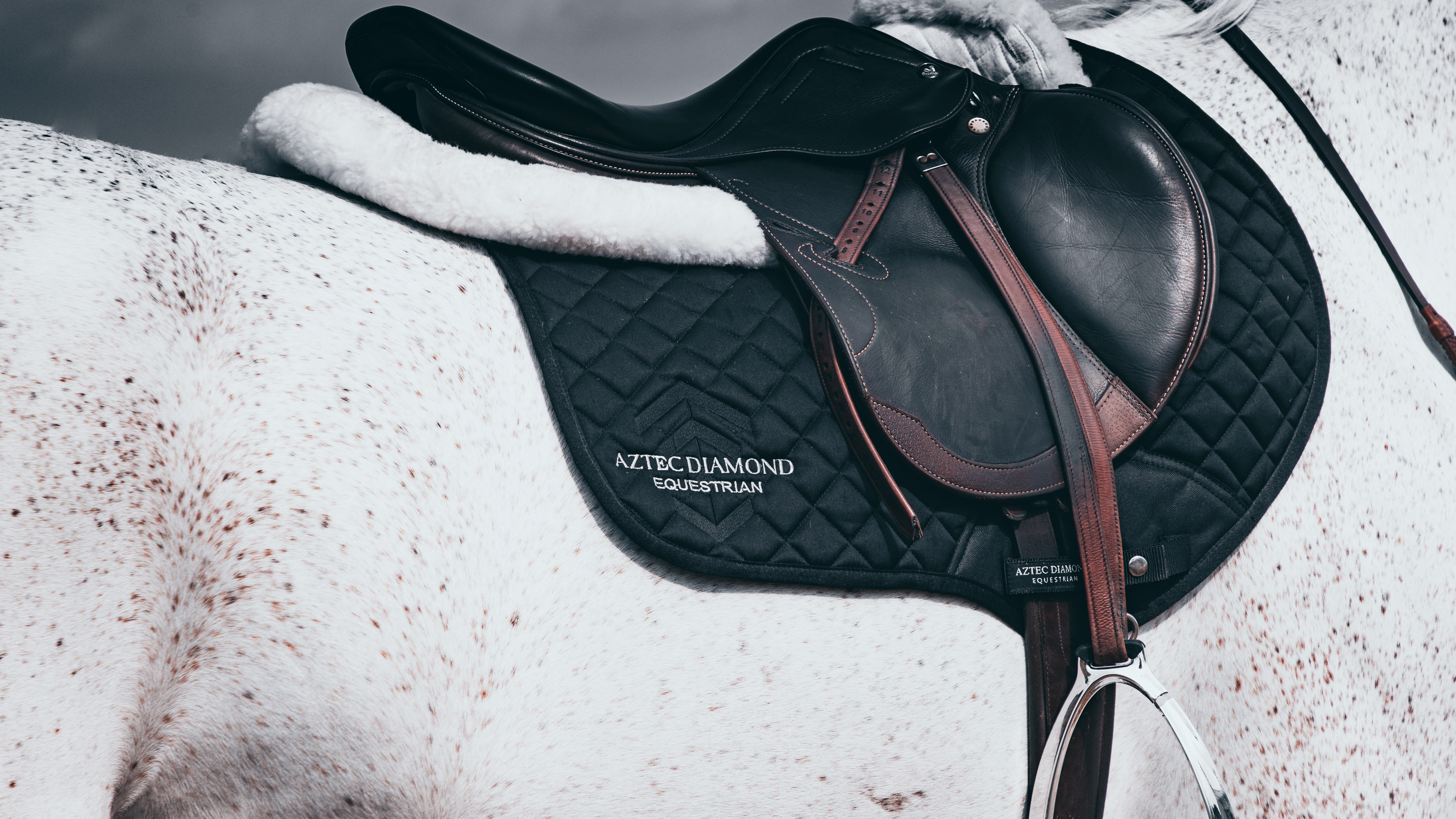 Editorial fashion cinematography for the Aztec Diamond 19 Collection, highlighting equestrian style and fabric motion.