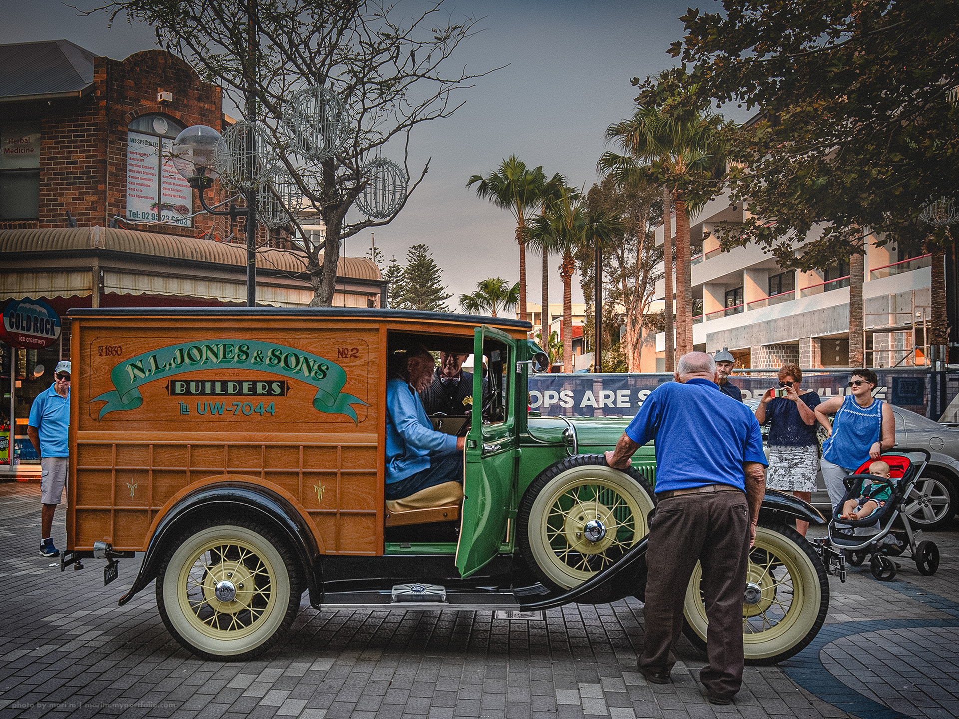 Smiling Ken, his friends, and his restored wooden truck. Ken had to drive many cars back on that day. So it seemed his friend was going to drive this truck to help Ken. Photographed by me at his car show in 2018