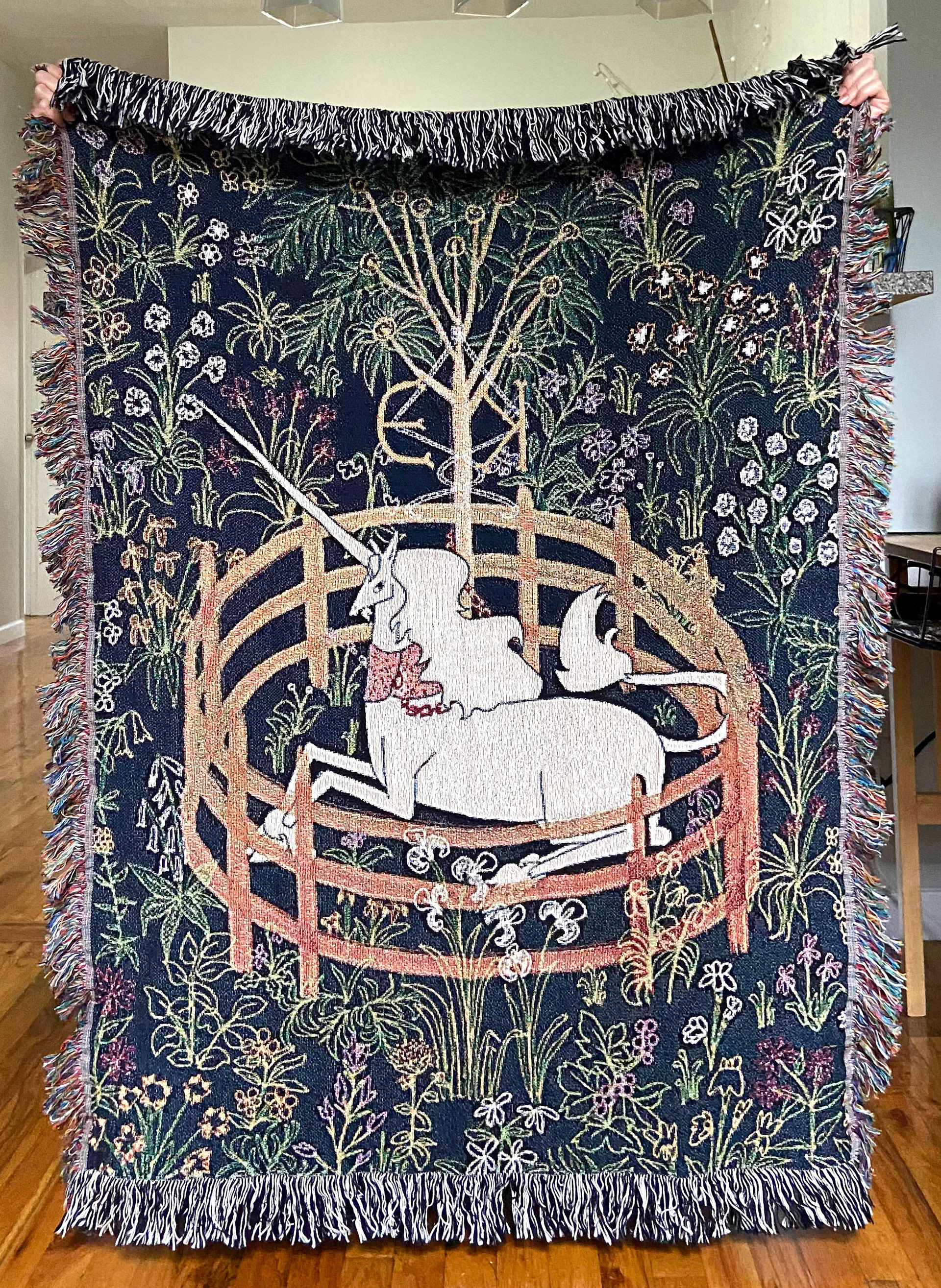 Woven wall tapestry by Edanur Kuntman depicting the Unicorn In Captivity Tapestry in her own style. This one is a smaller size of the previous one.