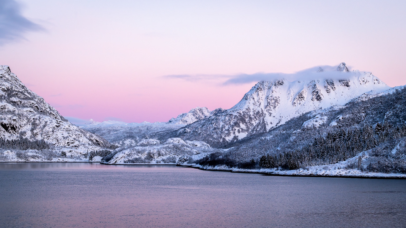 Magical Mountains - Norway.  Image taken from Hurtigruten MS Trollfjord looking across to a small town and snow covered peaks - Image taken 20-11-23