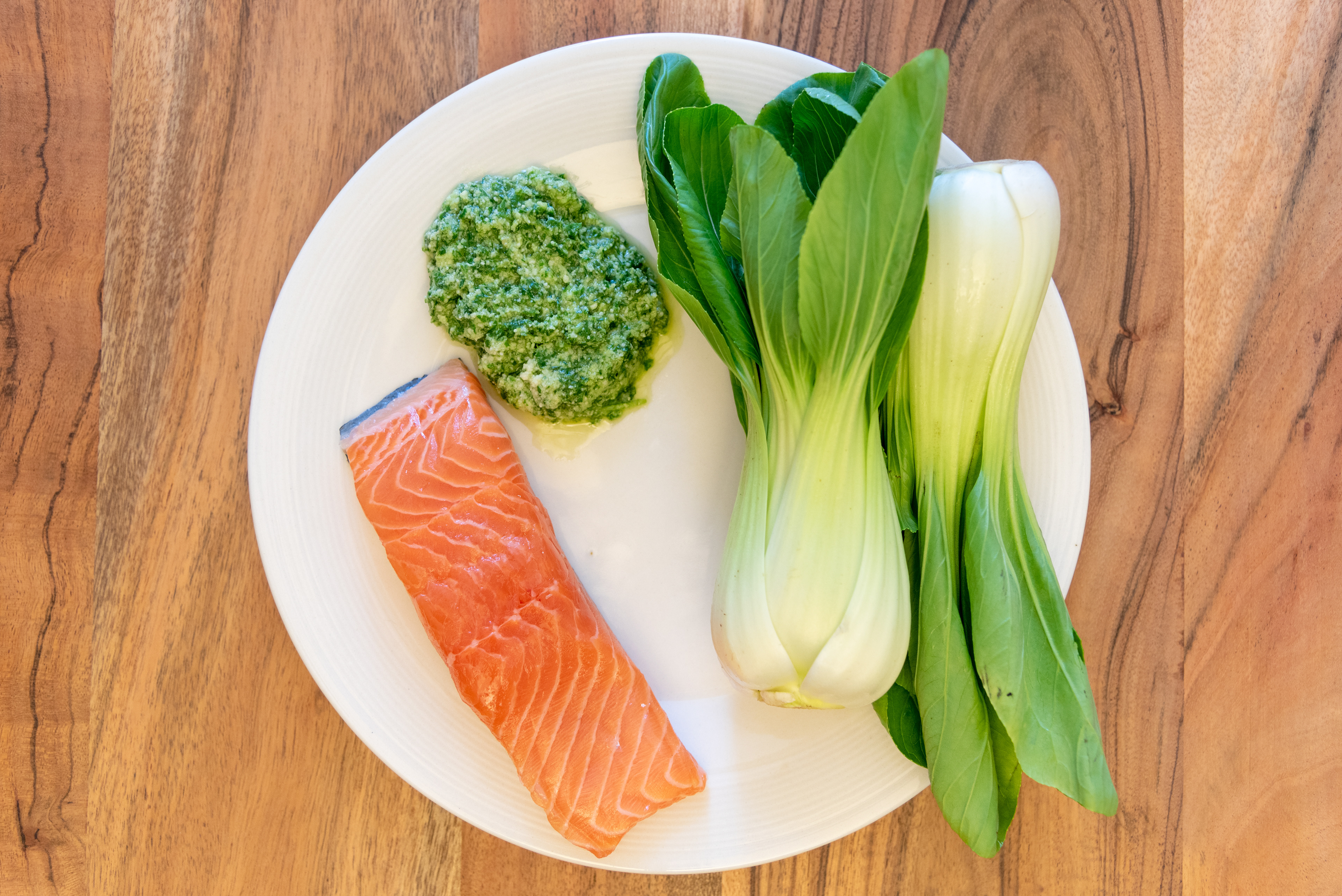 salmon pak choi homemade pesto on plate fresh raw keto low carb