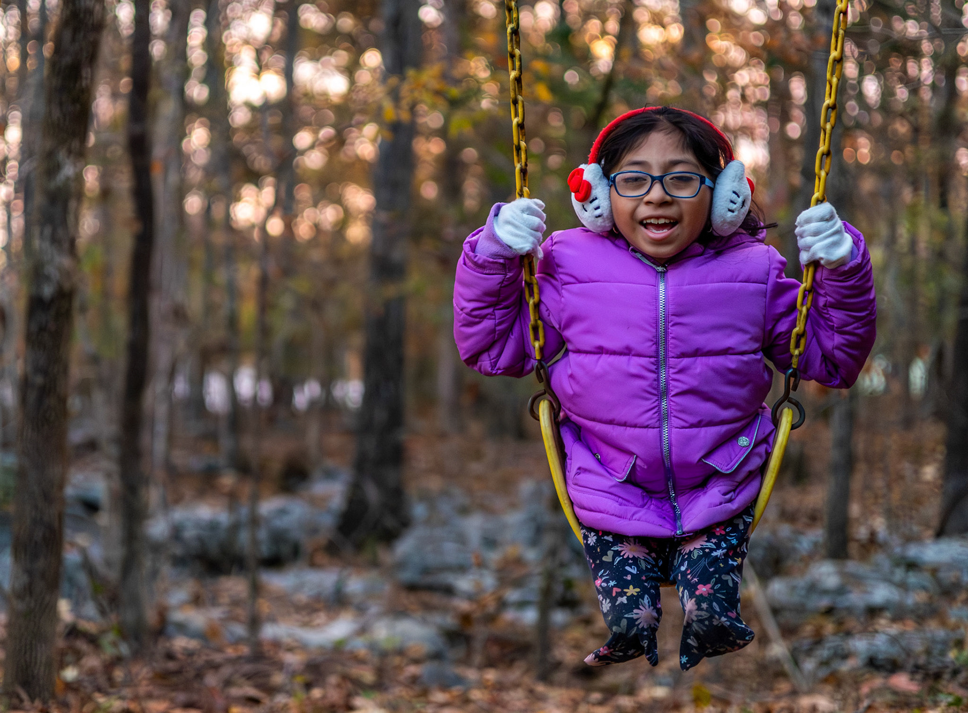 Gabriella, ‘Gabi,’ Leeanne Bilbrey, 8, swings in her backyard after school in Bowling Green, Ky., Nov. 12, 2025. Gabi was adopted two days after her birth in 2016. Her biological parents who had avoided medical care during pregnancy due to fear of deportation were unaware that her legs had not developed in utero. Despite her disability, Gabi lives life like any ordinary child, refusing to let her condition define her or stop her from doing what she loves.