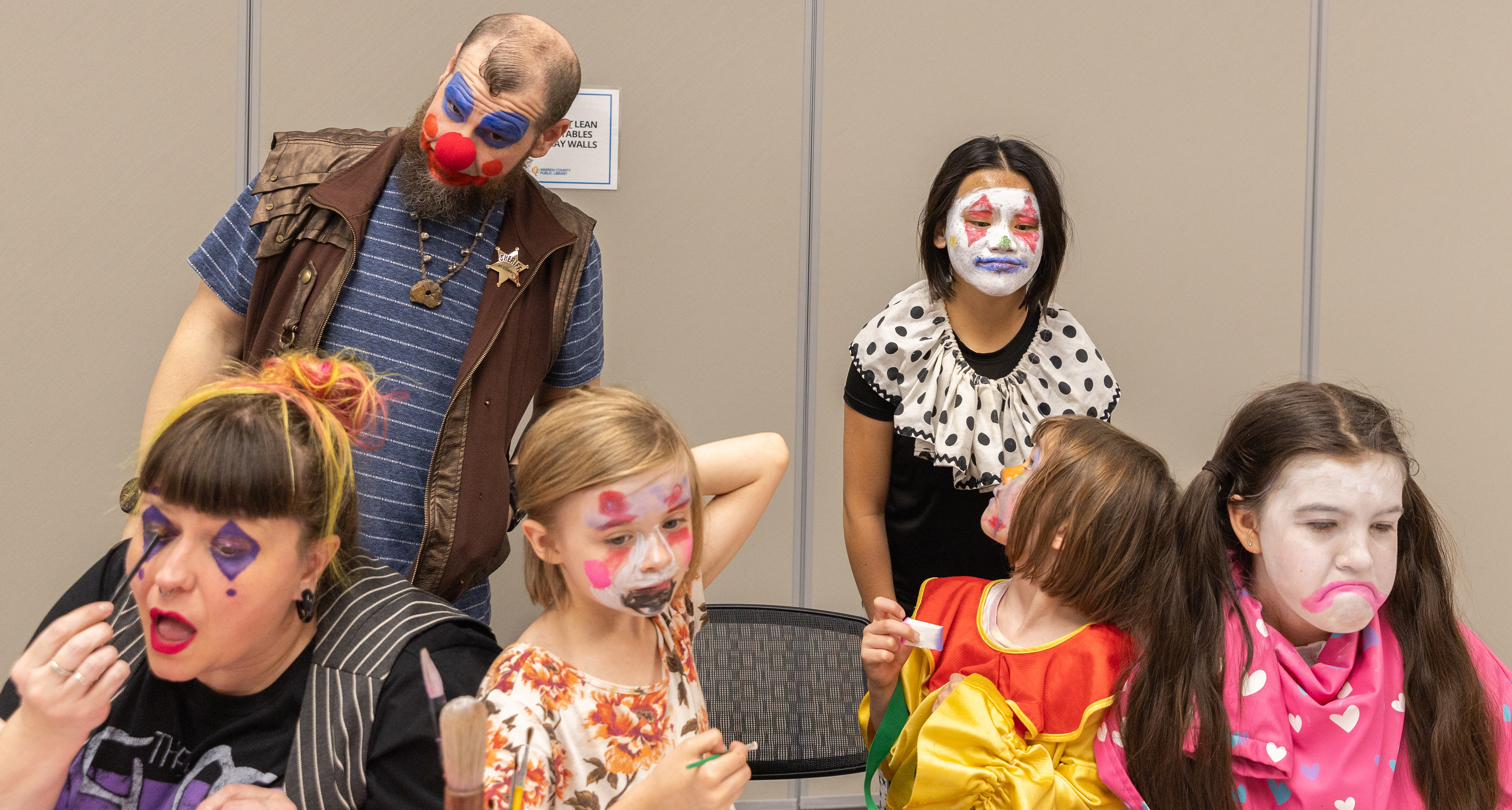 Shelly Glorioso, 34, left, and Coleman Glorioso, 34, celebrate their second wedding anniversary by applying clown makeup during the April Fools’ Clowning Hour at the Warren County Public Library Bob Kirby Branch in Bowling Green, Ky., on Wednesday, April 1, 2026. “We got married on April first because we are foolish,” Shelly said.