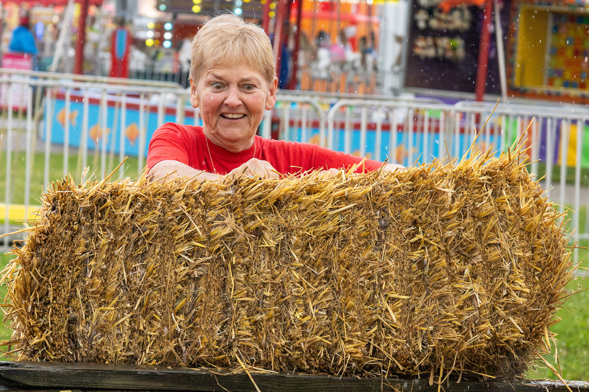 Peggy Downs competes in the Marion County Fair's inaugural hay bale toss despite the rain on Tuesday, July 7, 2026, in Lebanon, Kentucky. Downs placed third in the 17-and-older division.