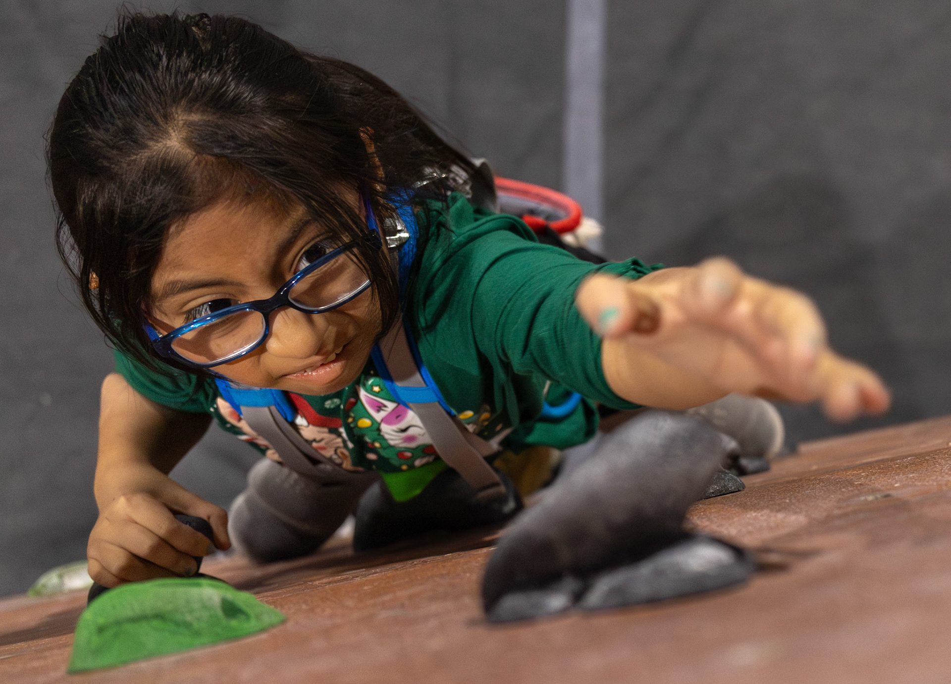 Gabi climbs to the top of the boulder wall during her first level climbing class on Dec. 3, 2025. The boulder wall is the hardest wall for her to climb due to her balance.