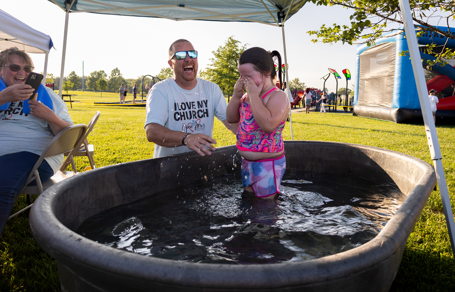 Skylar Bickett is baptized by members of Open Arms Community Church during Lights Over Lebanon Fourth of July celebration at Graham Memorial Park on July 4, 2026, in Lebanon, Kentucky.