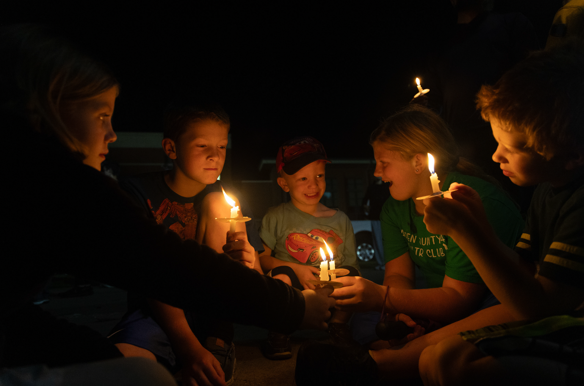 A family attends a candlelight vigil held to honor the life of Charlie Kirk at Western Kentucky University, on Thursday, Sept. 25 ,2025.