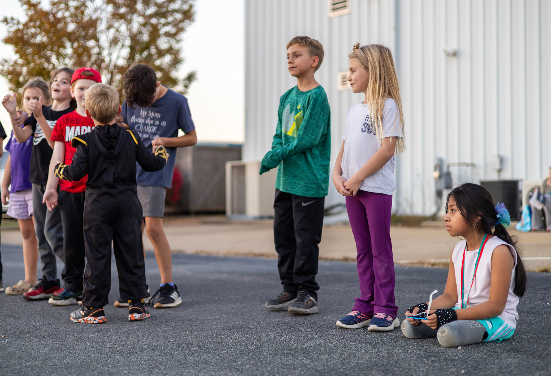 Gabi joins a line with her first level rock climbing group as they play telephone during a Halloween party at Redpoint Climbing Center in Bowling Green, Ky., on Nov. 6, 2025.