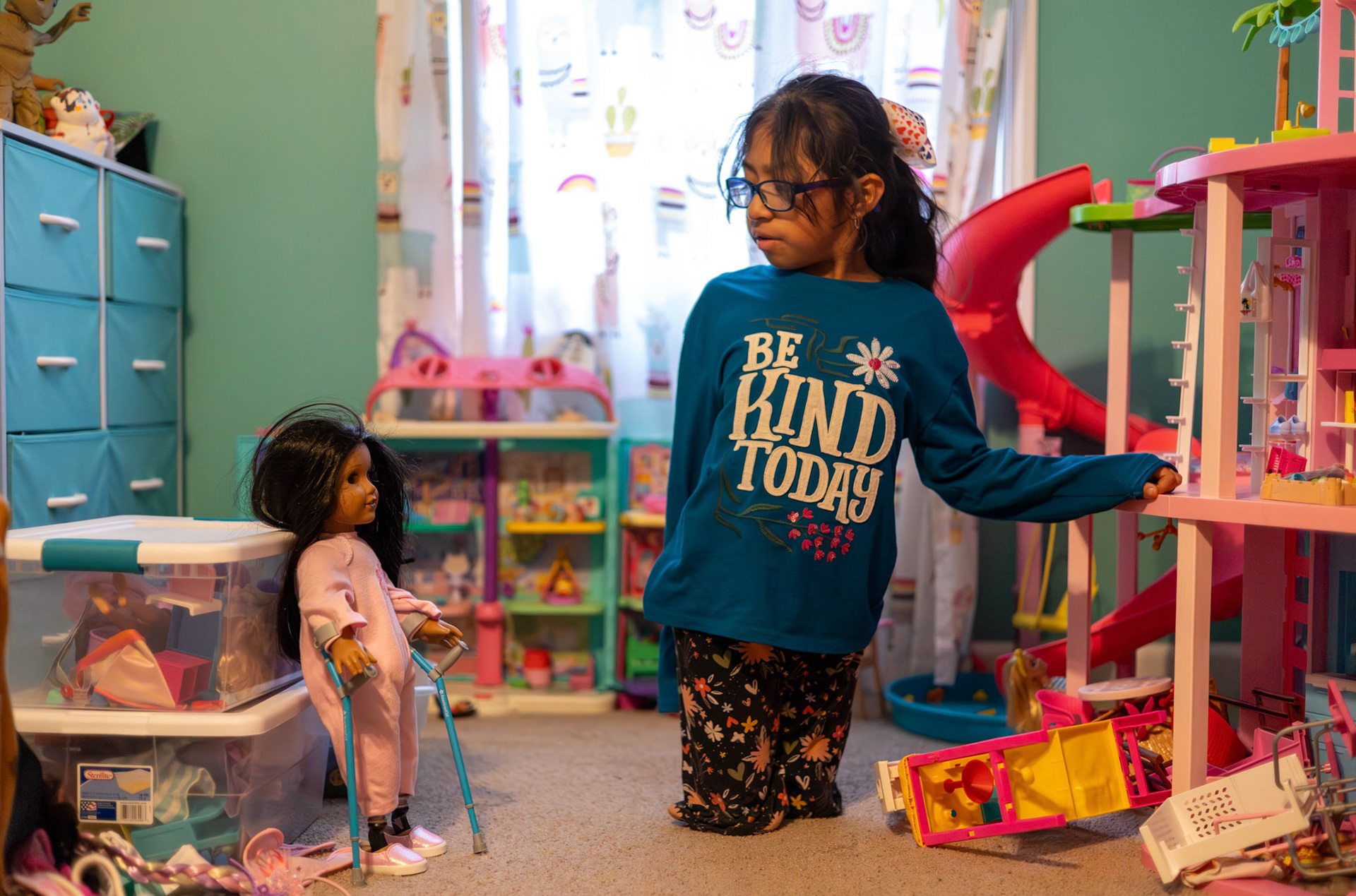 Gabi stops and stares at her American Girl doll in her room on Nov. 12, 2025. "Sometimes I play with my American Girl Doll,” Gabi said when asked if she plays with any of her toys. “She looks like me.”