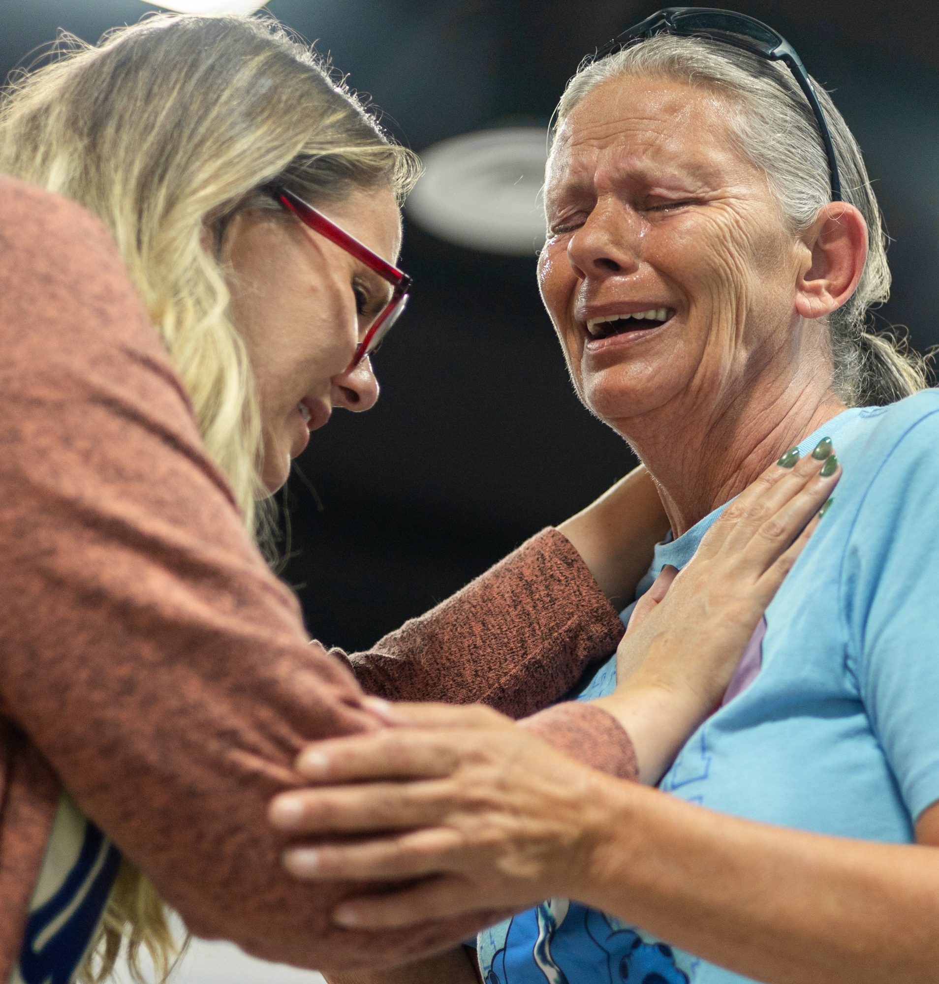 Minister Lisa Wright prays over Rhonda Sams during Summer Fest at Loretto City Hall, hosted by Abundant Life Church, on June 18, 2026, in Loretto, Kentucky. An emotional Sams said she was overcome by what she described as the power of God. "I felt God with me. He's always with me. I was saved in '99, but I just needed to feel him more. I fall short every day," Sams said.