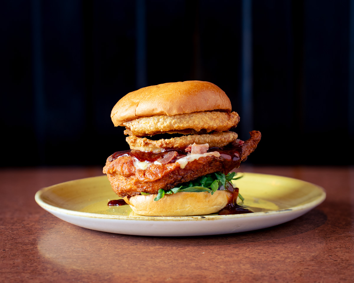 A deep filled chicken burger on a plate