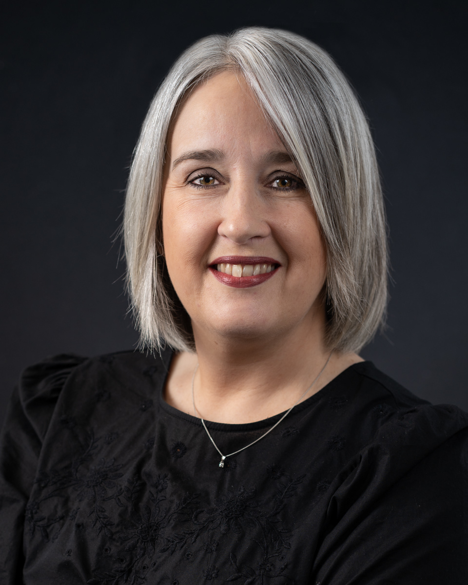 studio headshot lady on black background