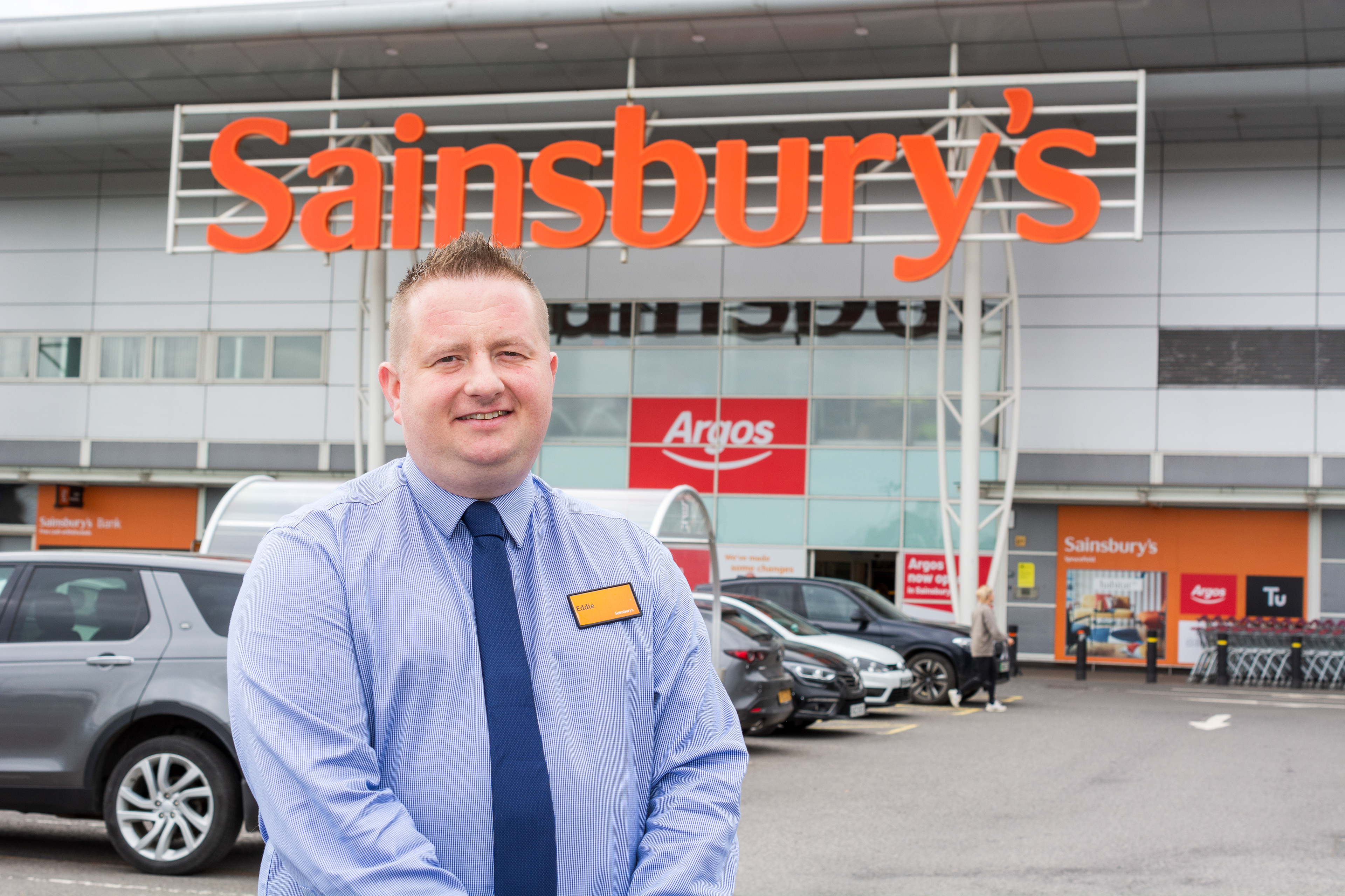 the store manager photographed at the front of his premises