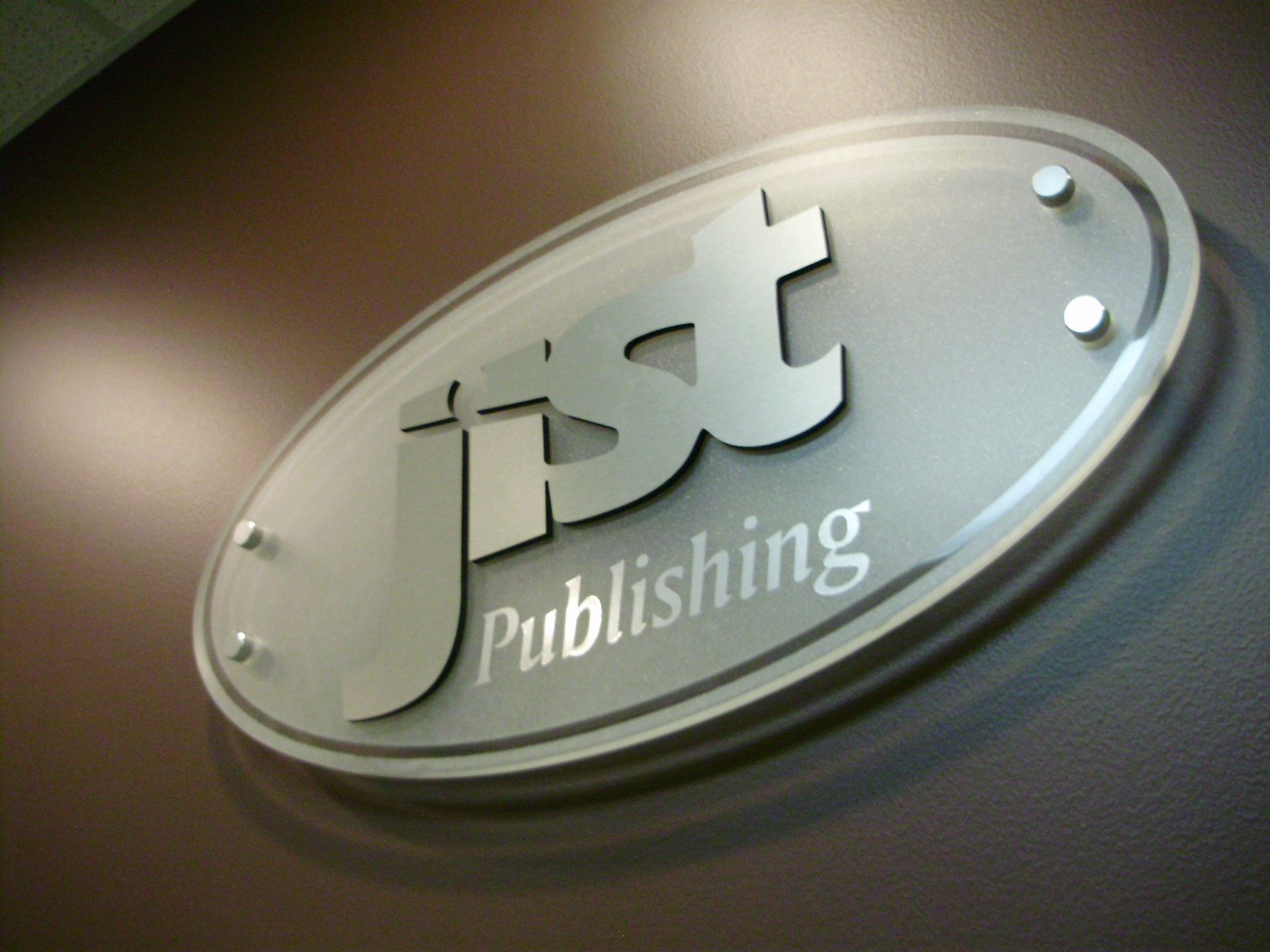 JIST Publishing brushed metal on frosted glass signage