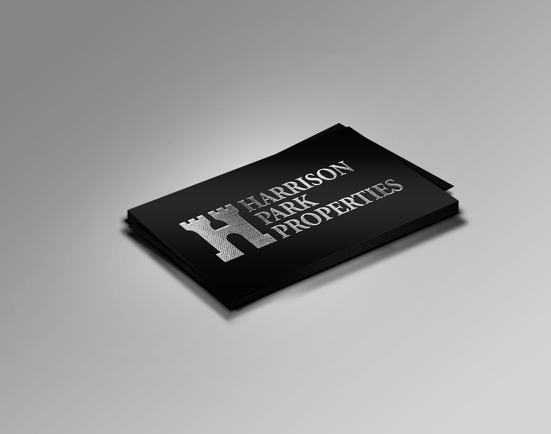 Harrison Park Properties business card with foil logo