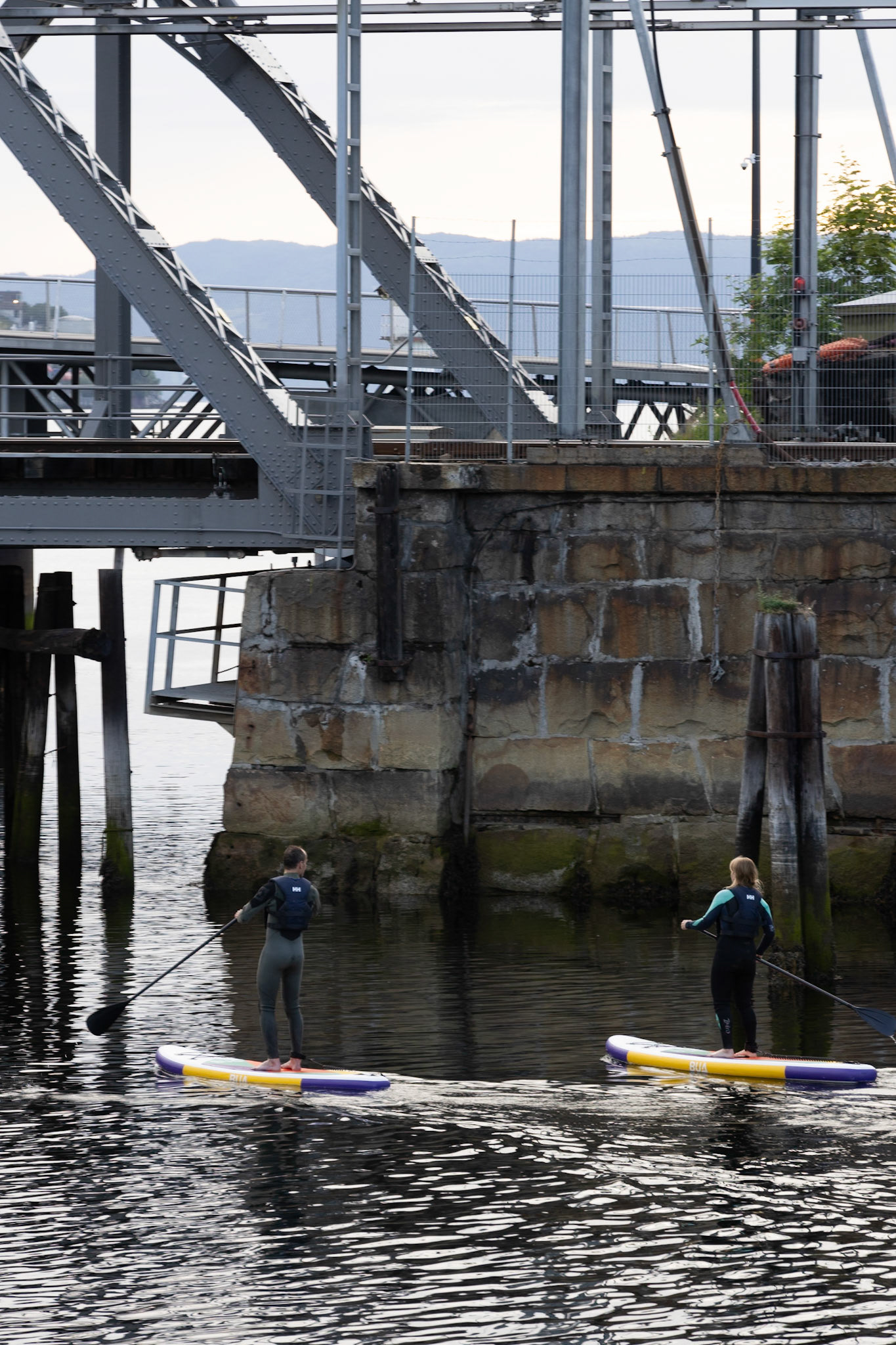 SUP'ers near the Nidelven outlet and massive railway cantilever bridge. 