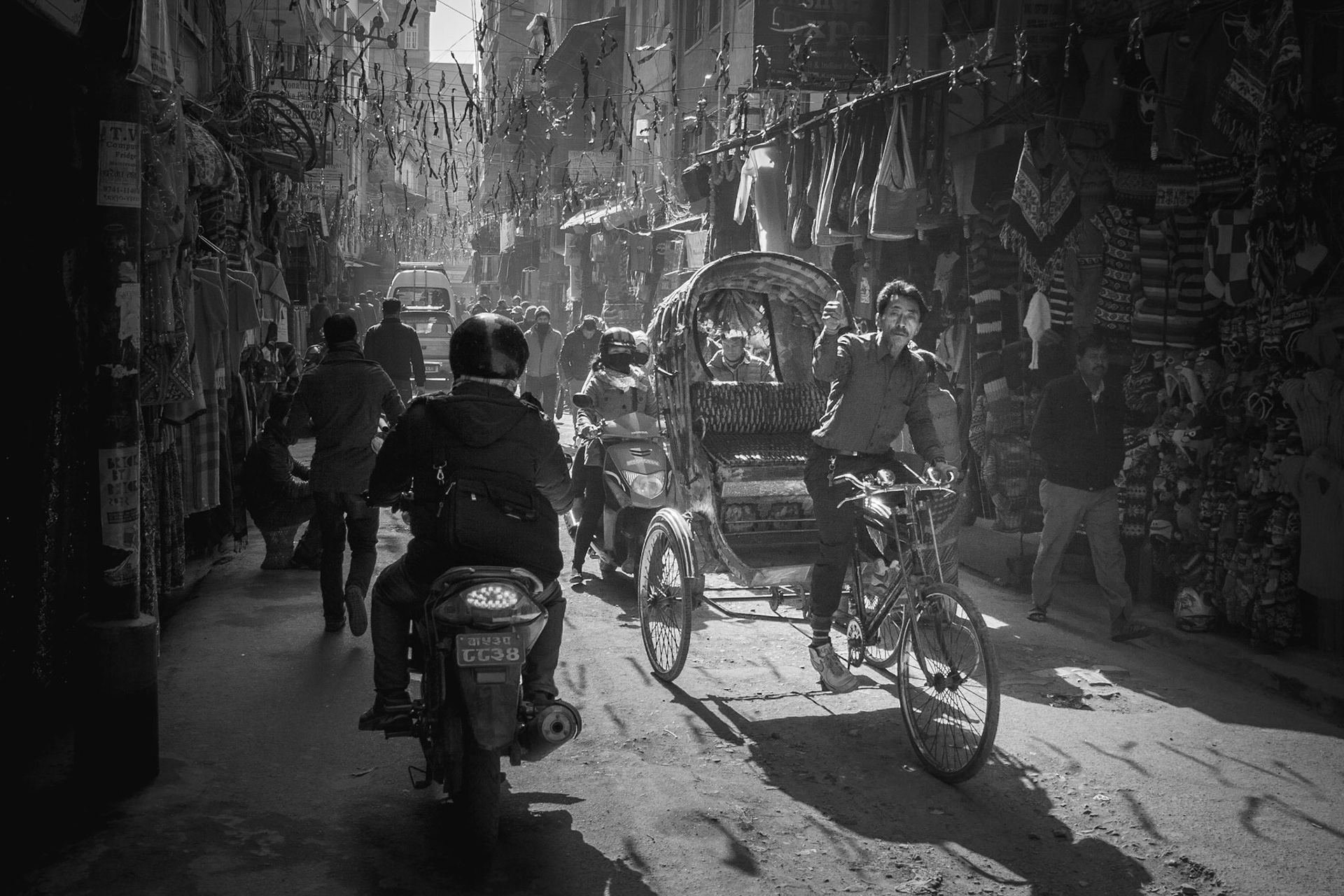 Bike rickshaw riders try to catch your attention many ways to offer their services. From tooting horns to shouting at you.