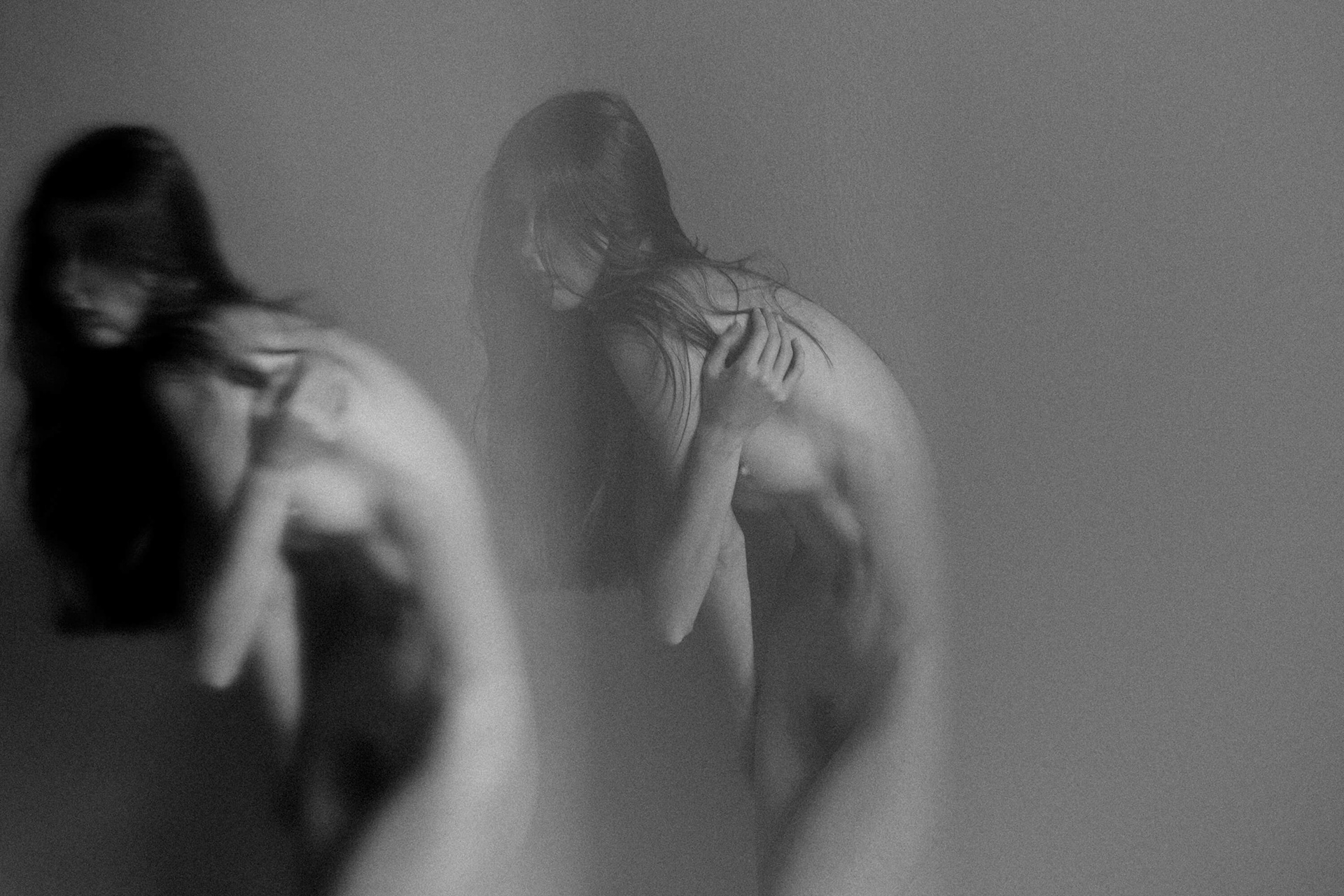 Abstract fine art nude photography with soft blur and layered reflections