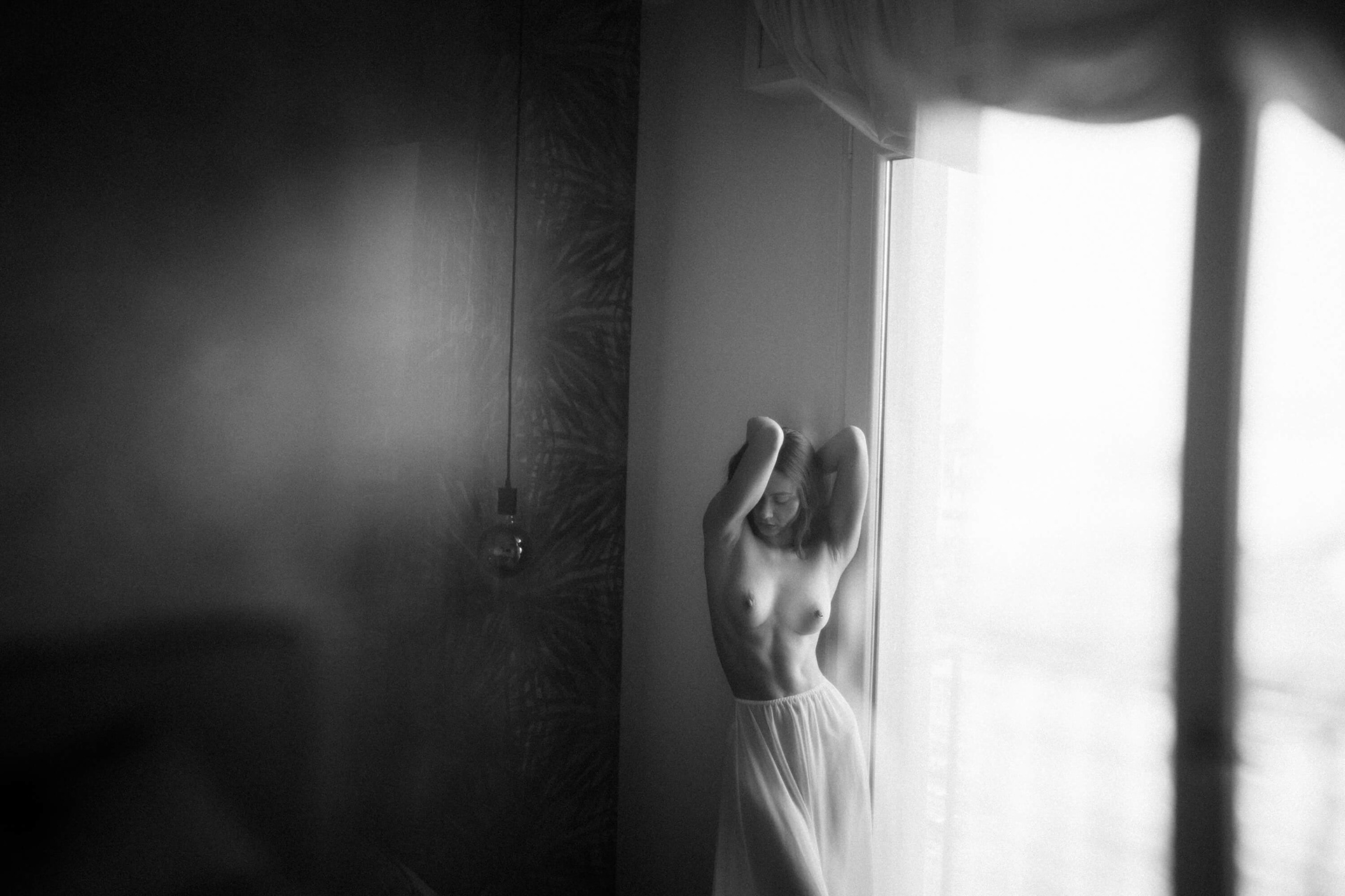fine art nude portrait of woman in natural light by window