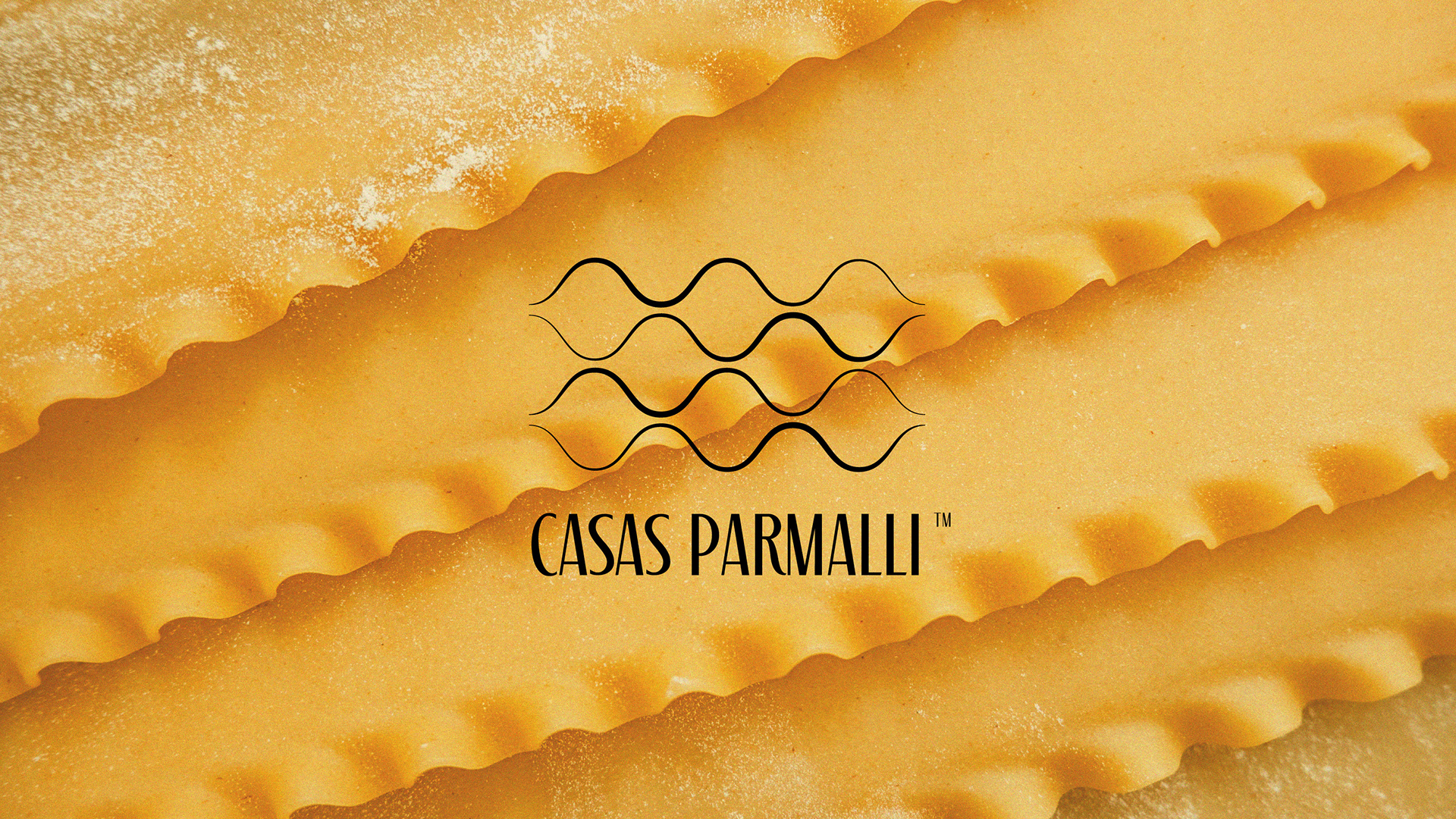 Logo Casas Parmalli sobre fundo de massa artesanal como parte do rebranding e identidade visual