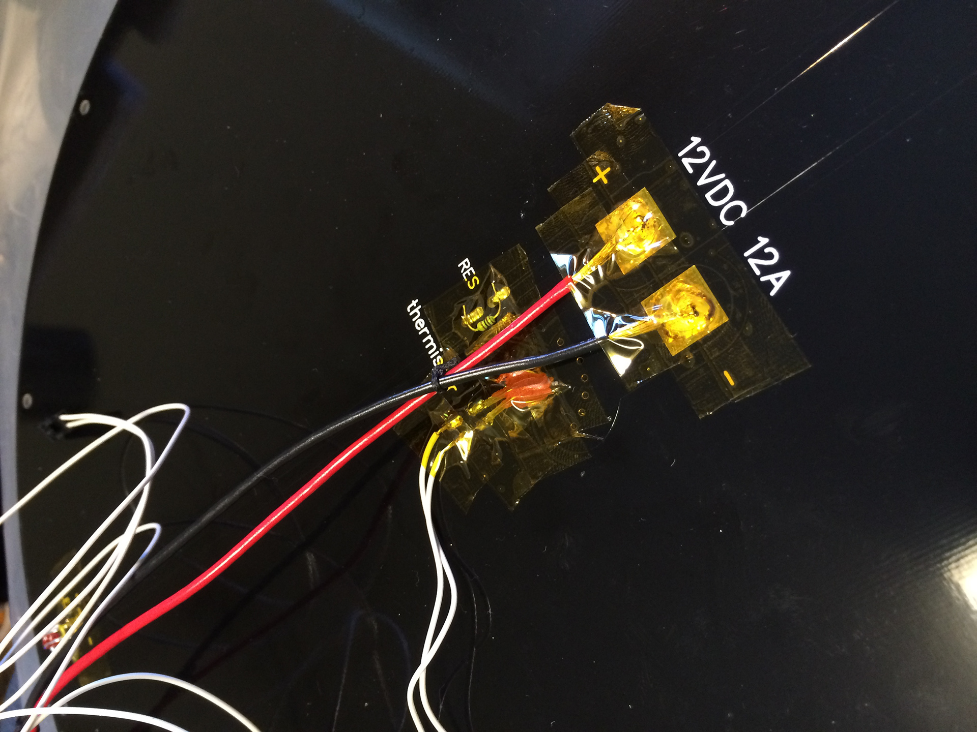 Soldering the heating wires to the bed.