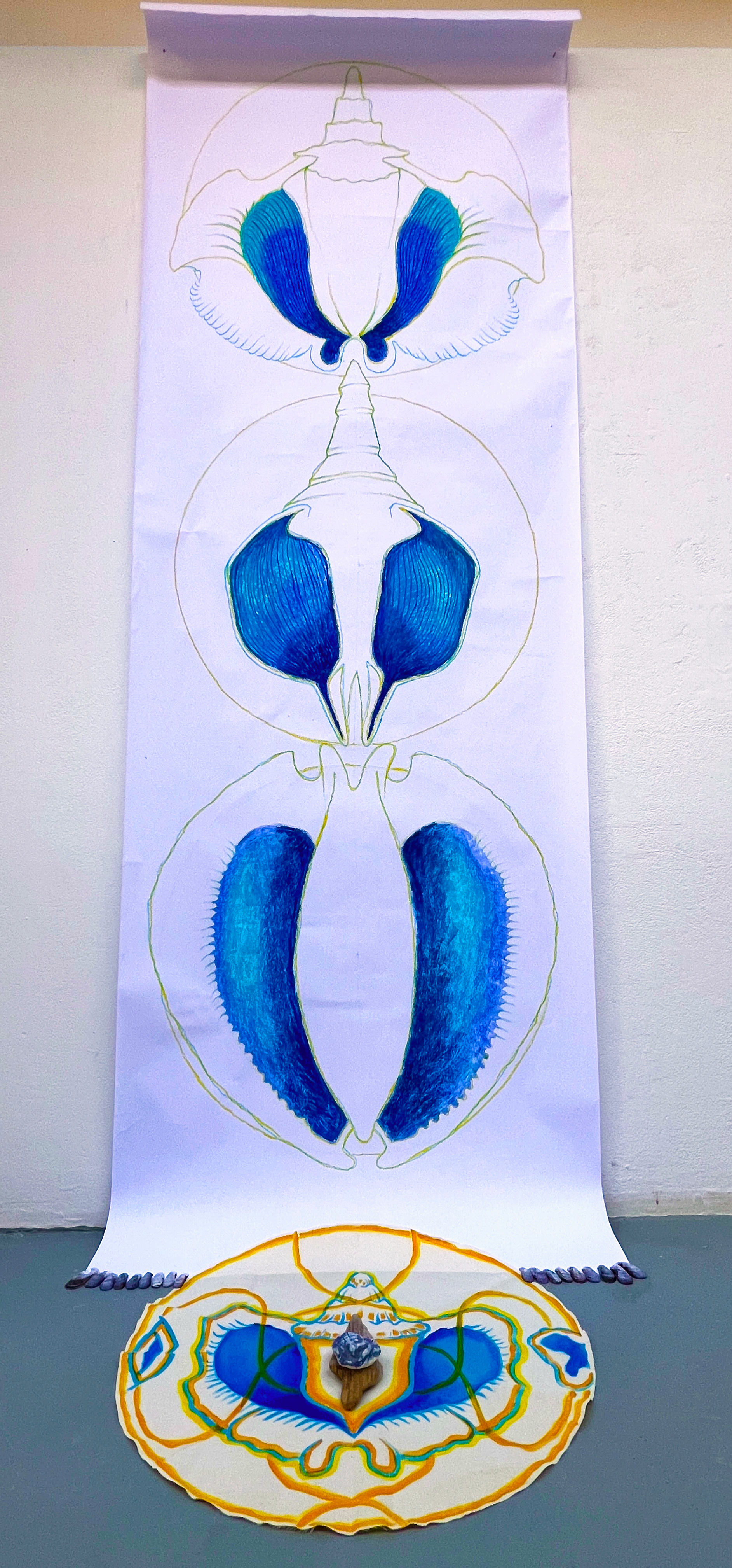 Song Shrine, UCA Farnham (Paper, calico, coloured pencils, oil pastels, acrylic paint,  ceramic, driftwood, mussel shells) 80 x 80 x 200cm (approx.) (2025)