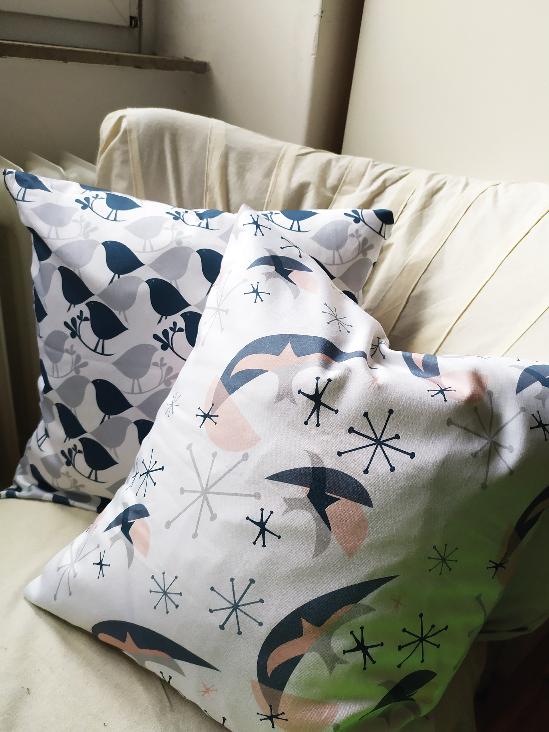 The finished cushion covers on the armchair covered with trial fabric