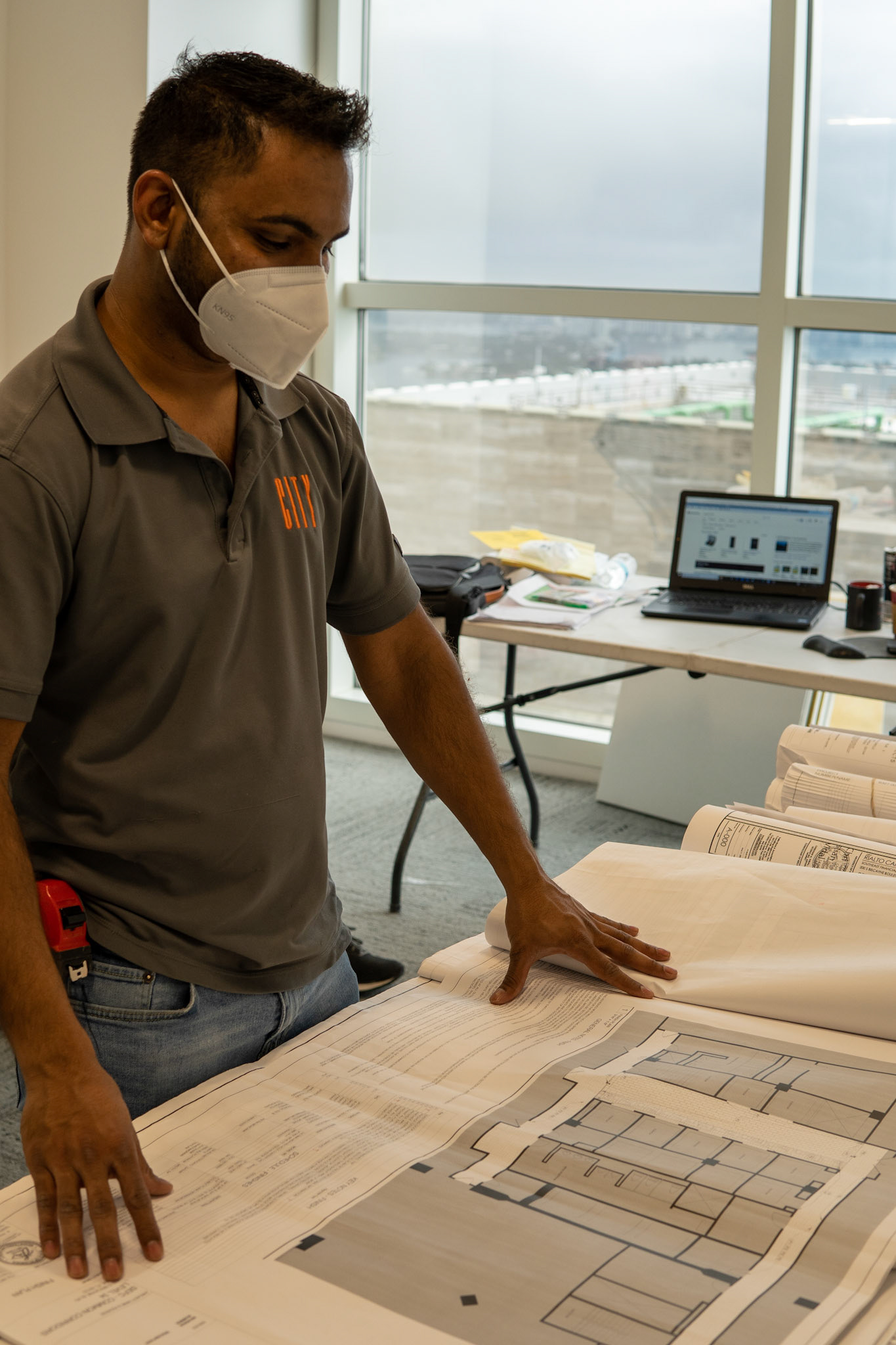 A Project Manger reviews his floor plans.