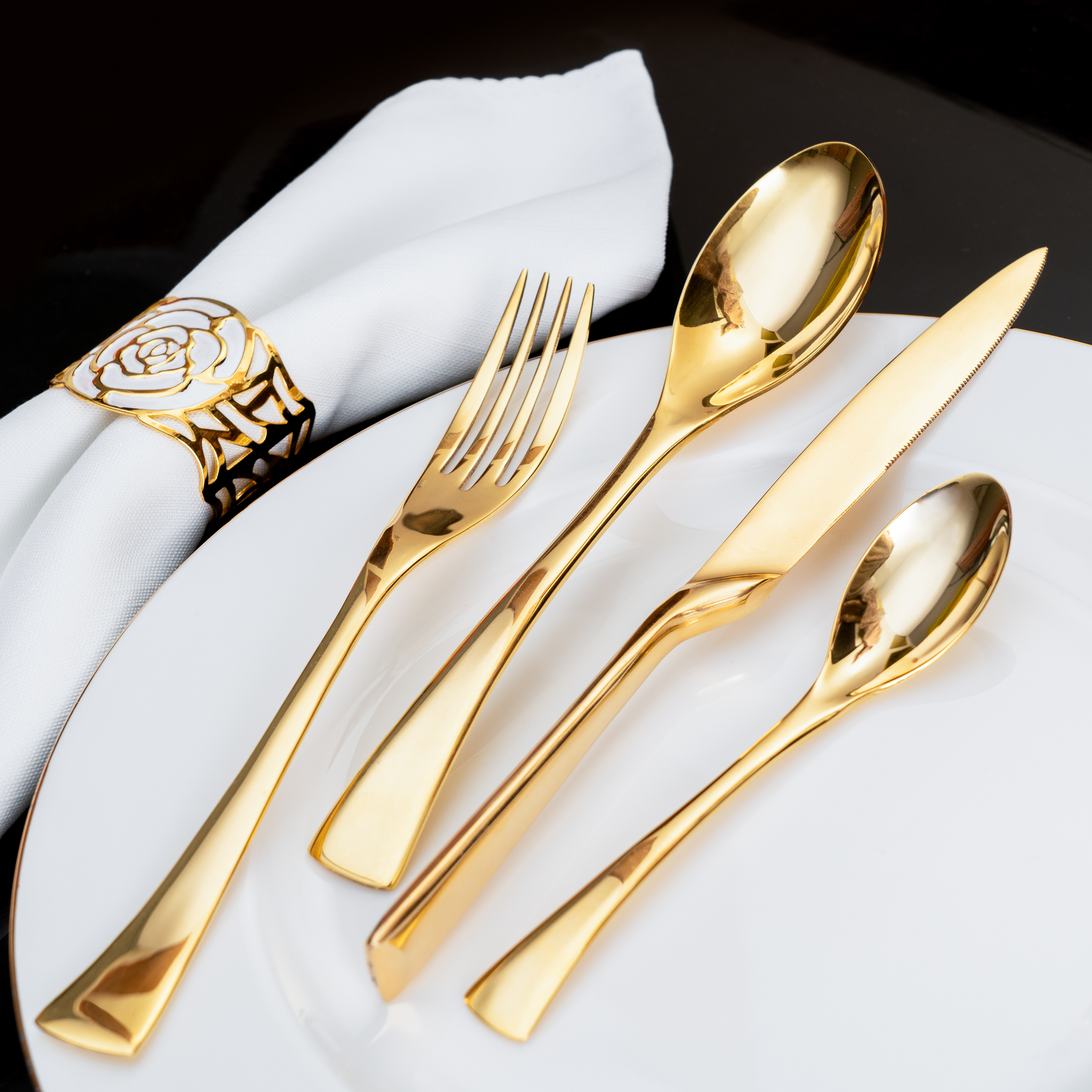 Artistic shot of golden cutlery set including spoon and knife – premium crockery product photography in Lahore