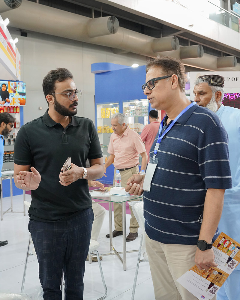 Candid networking and visitor interaction at a Victorian business expo.