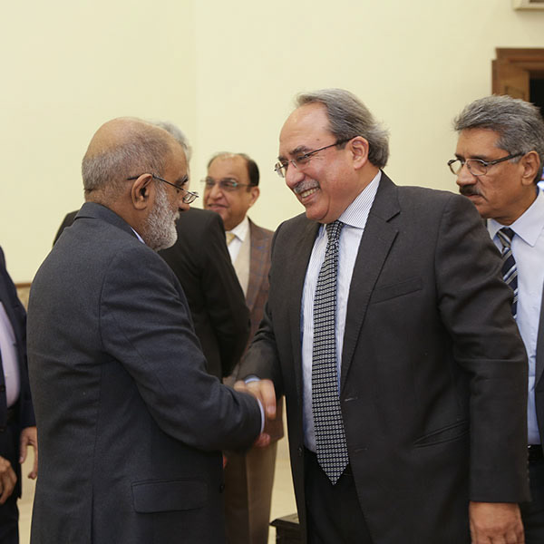 Attendees networking and greeting each other at corporate event – candid business interaction photo