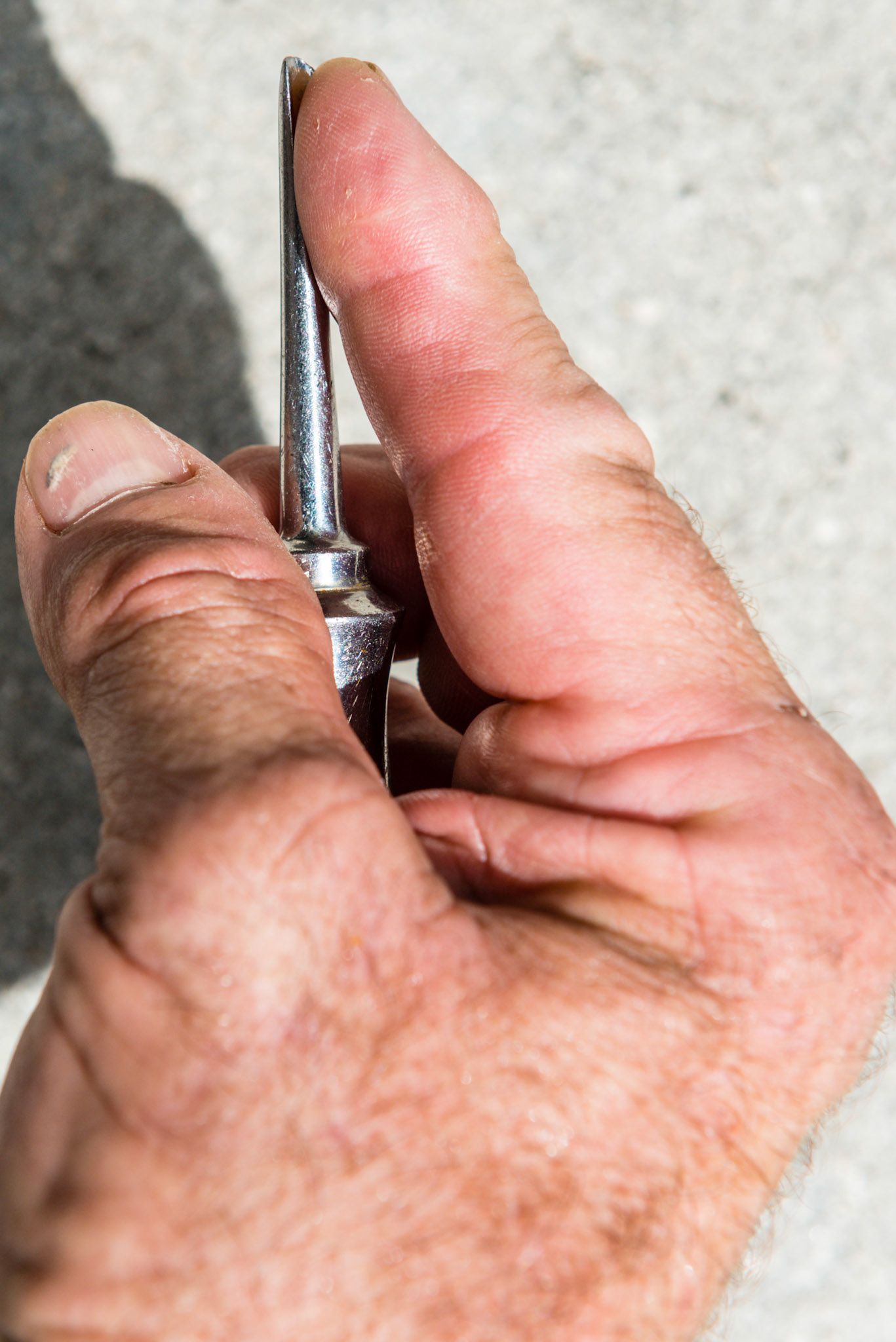 Forefinger and elevator tip facing up, closed side of fist.